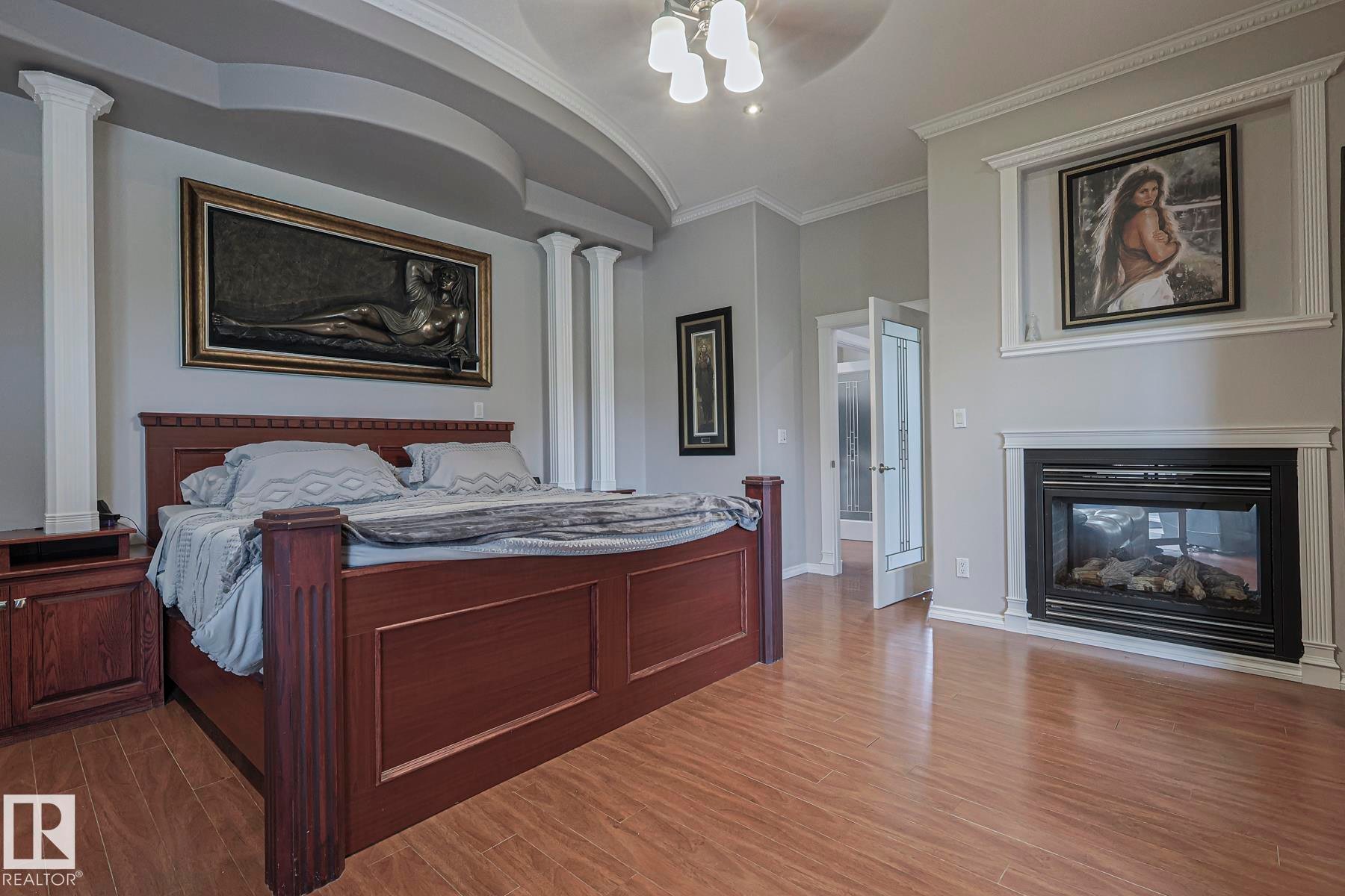 4 Third Avenue, Entwistle, AB - Indoor Photo Showing Bedroom With Fireplace