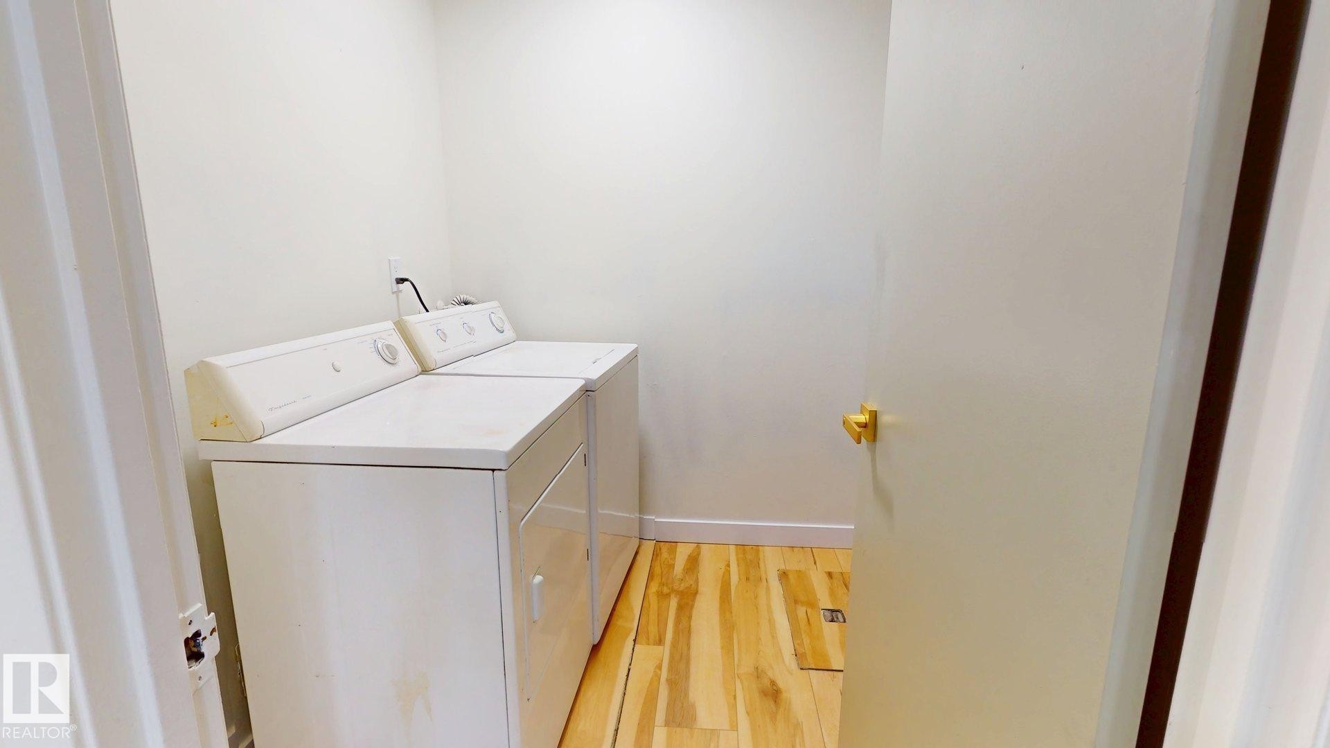 Washroom featuring light wood-style floors and washer and clothes dryer - 114 2908 116A Avenue, Edmonton, AB - Indoor Photo Showing Laundry Room