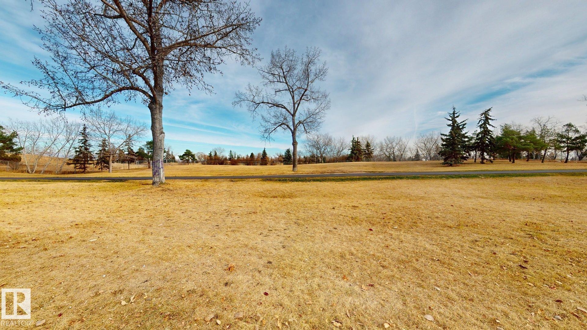 View of grassy yard featuring a view of countryside - 114 2908 116A Avenue, Edmonton, AB - Outdoor With View