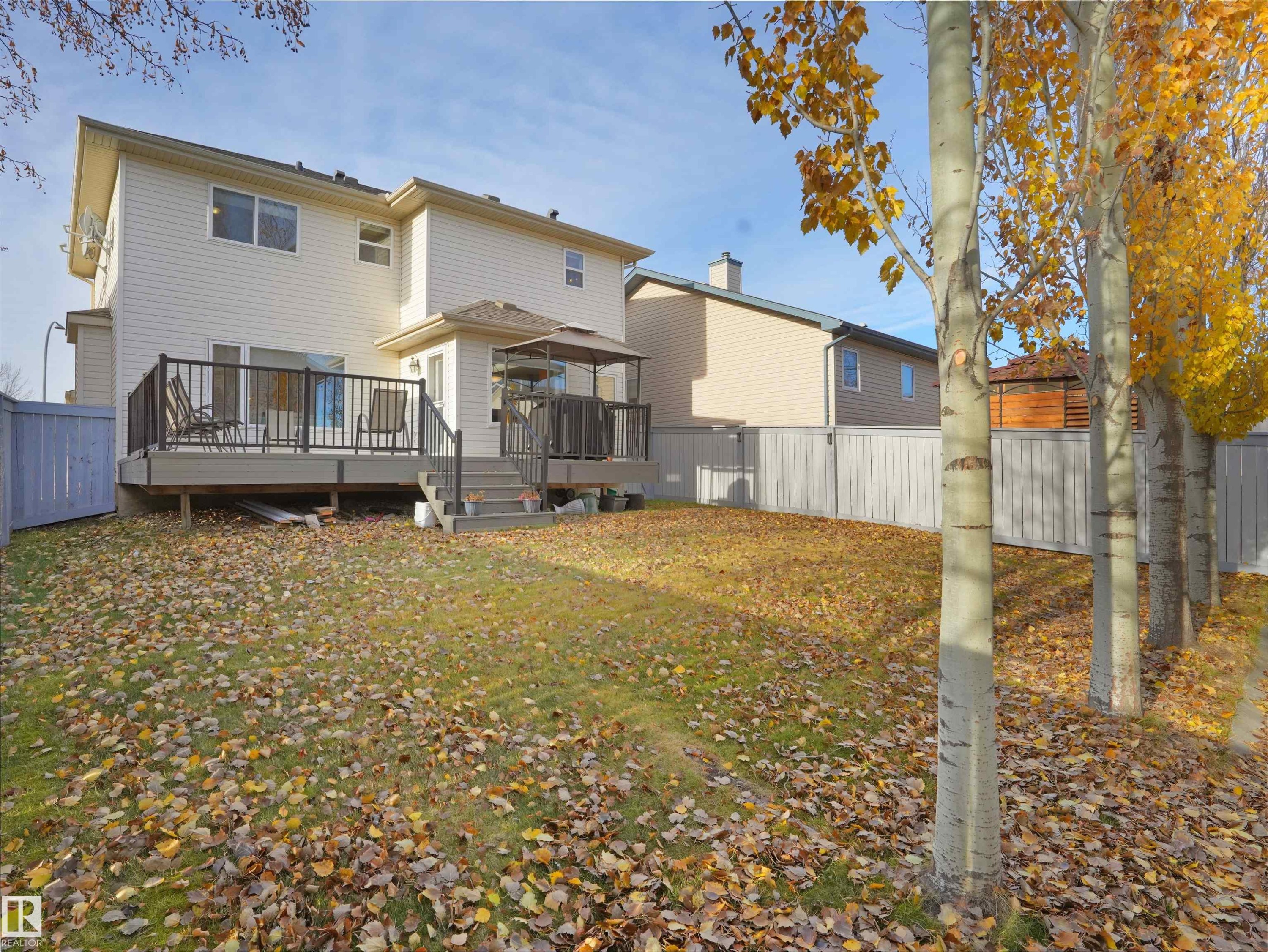 Back of house with a fenced backyard, a deck, and a gazebo - 94 Dechene Road, Edmonton, AB - Outdoor With Deck Patio Veranda With Exterior
