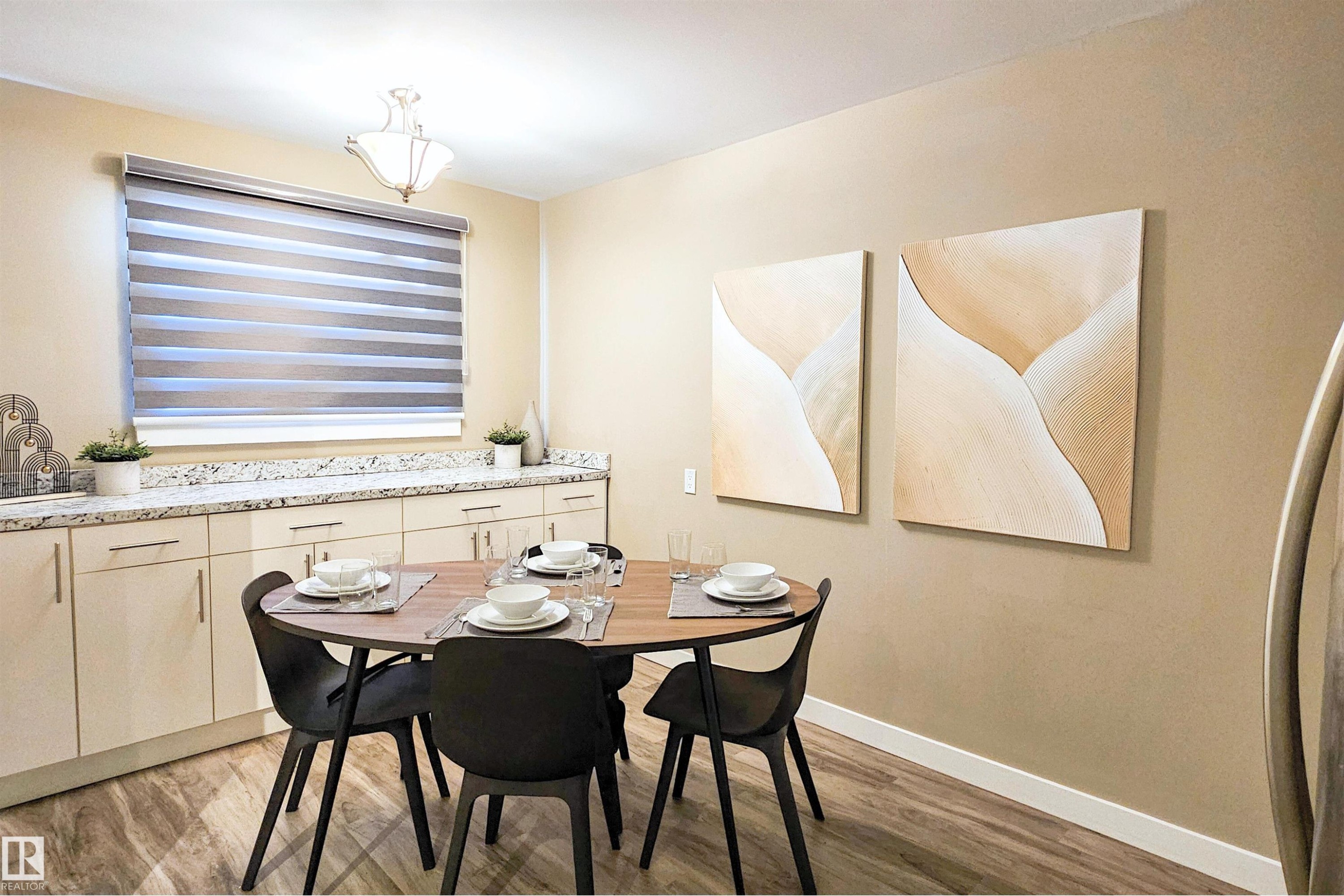 Dining space with baseboards and light wood-type flooring - 4203 83 Street, Edmonton, AB - Indoor Photo Showing Dining Room