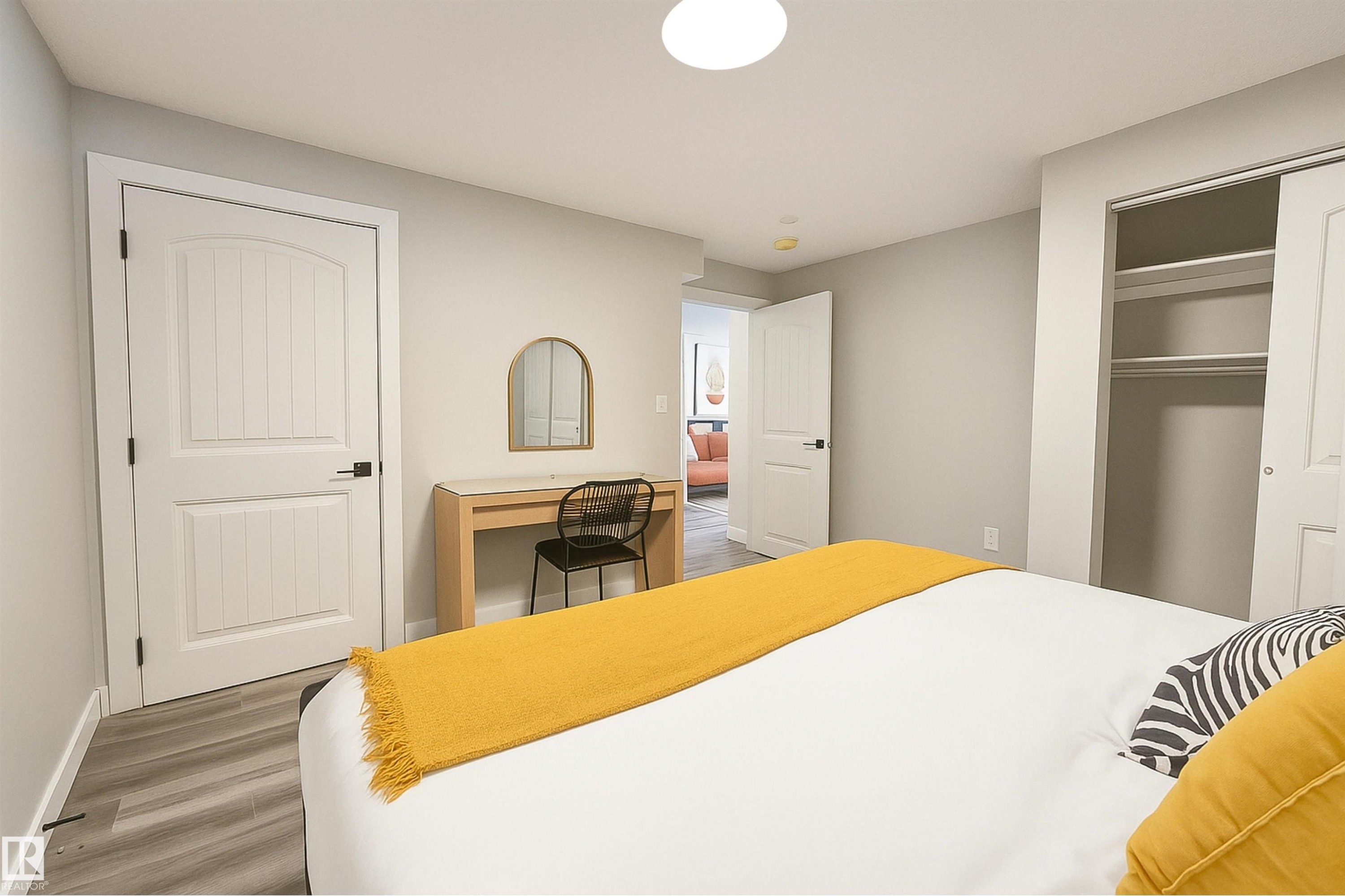 Bedroom with wood finished floors, a closet, and an office area - 4203 83 Street, Edmonton, AB - Indoor Photo Showing Bedroom