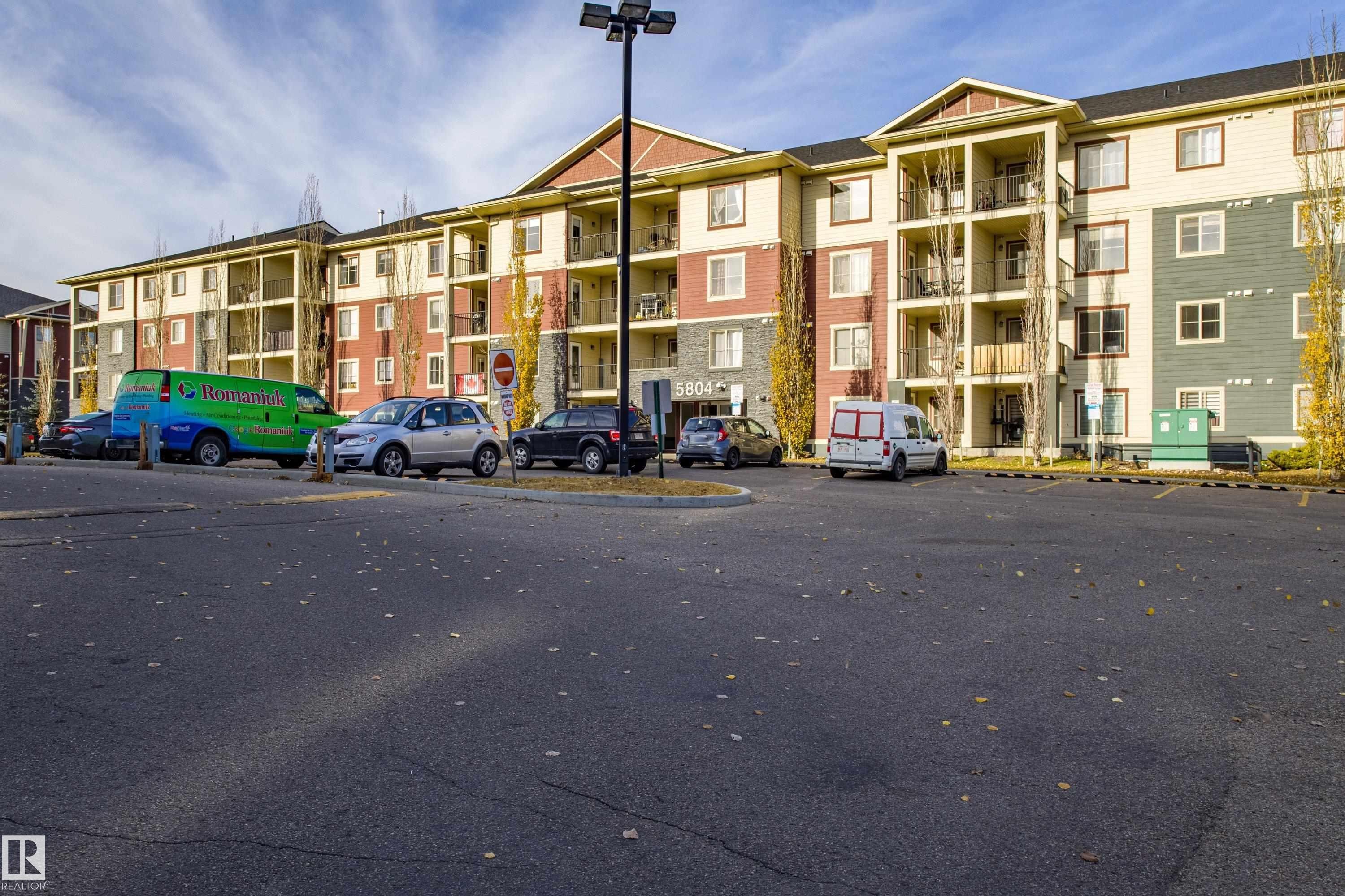 View of apartment building / complex featuring uncovered parking - 201 5804 Mullen Place, Edmonton, AB - Outdoor With Balcony With Facade