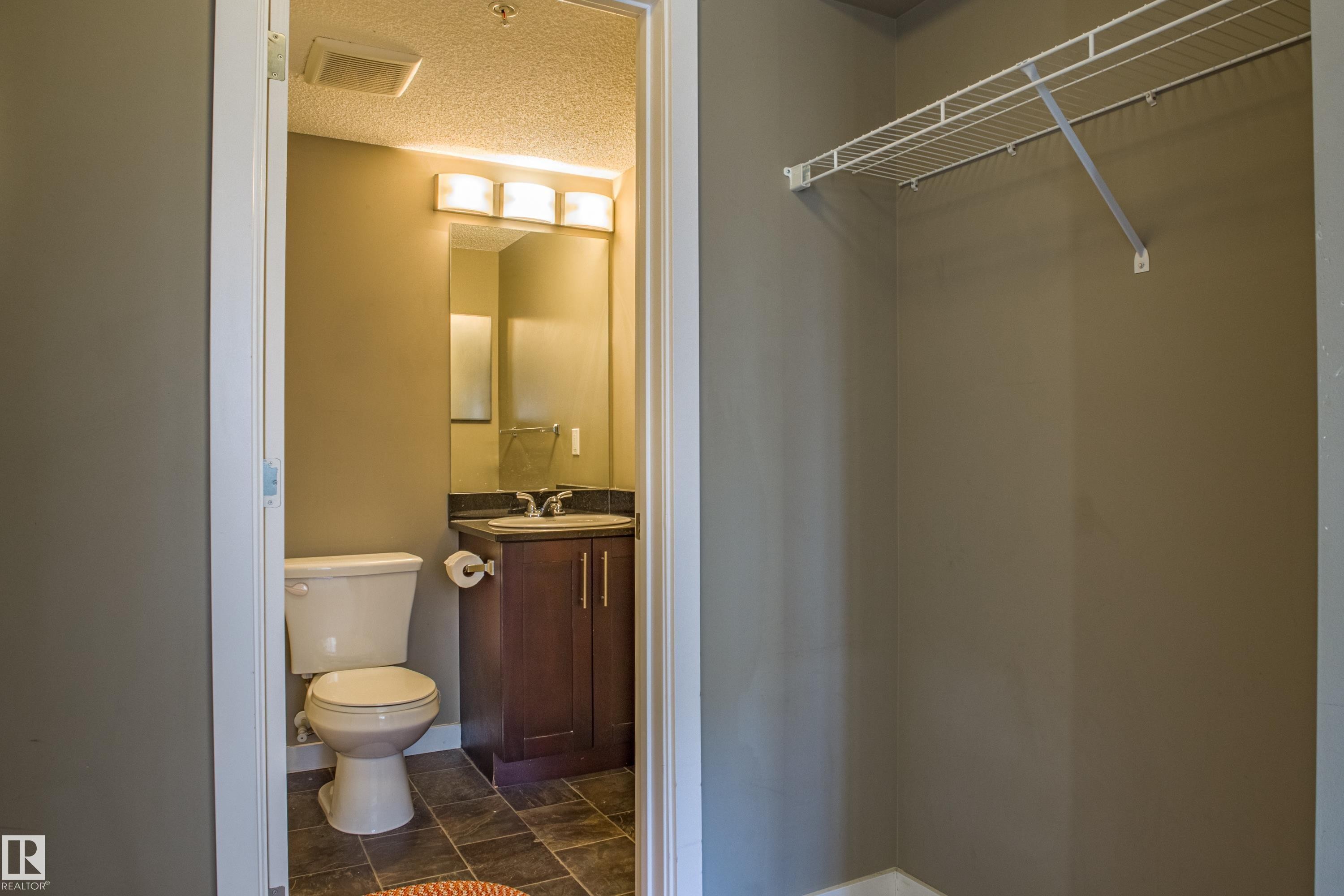Half bathroom with vanity and a textured ceiling - 201 5804 Mullen Place, Edmonton, AB - Indoor Photo Showing Bathroom