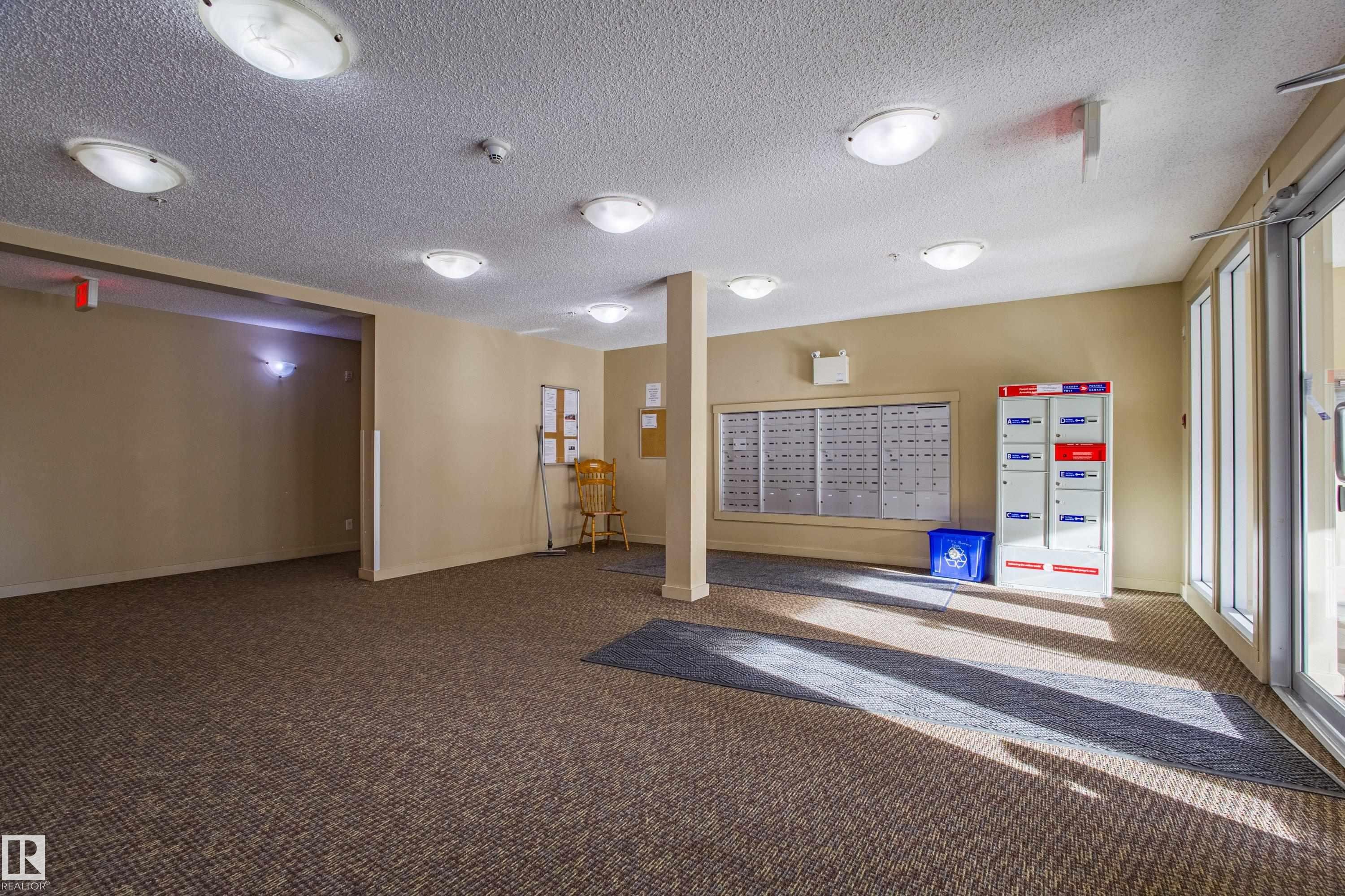 Lobby with a textured ceiling - 201 5804 Mullen Place, Edmonton, AB - Indoor Photo Showing Other Room