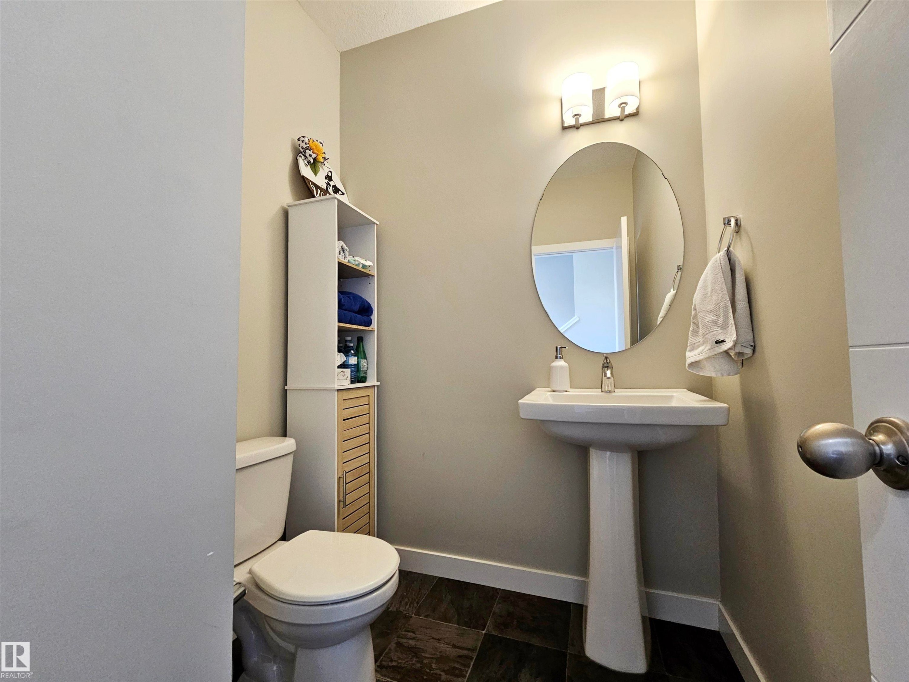 Half bath featuring baseboards and toilet - 83 600 Bellerose Drive, St. Albert, AB - Indoor Photo Showing Bathroom