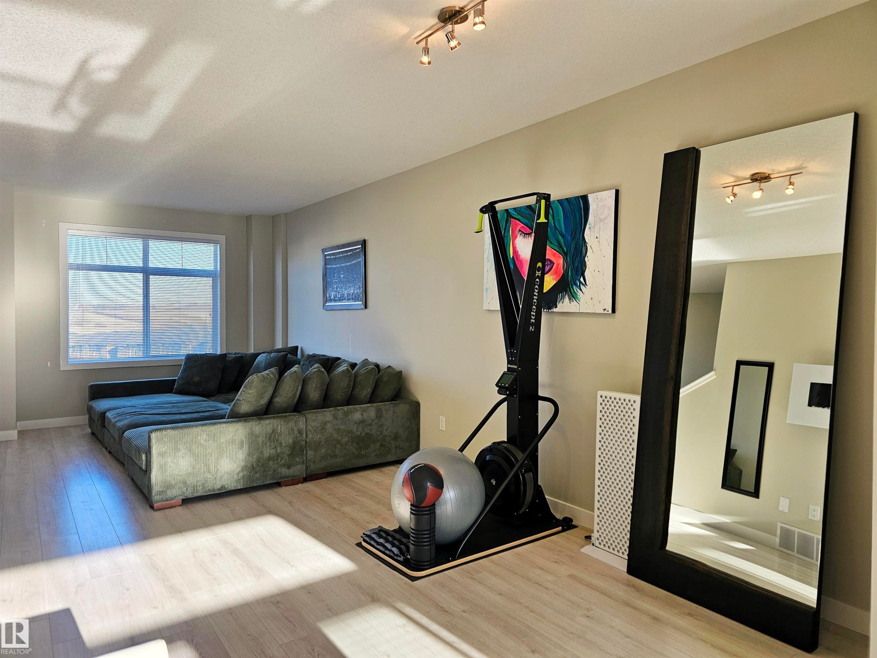 Exercise room with wood finished floors - 83 600 Bellerose Drive, St. Albert, AB - Indoor Photo Showing Living Room