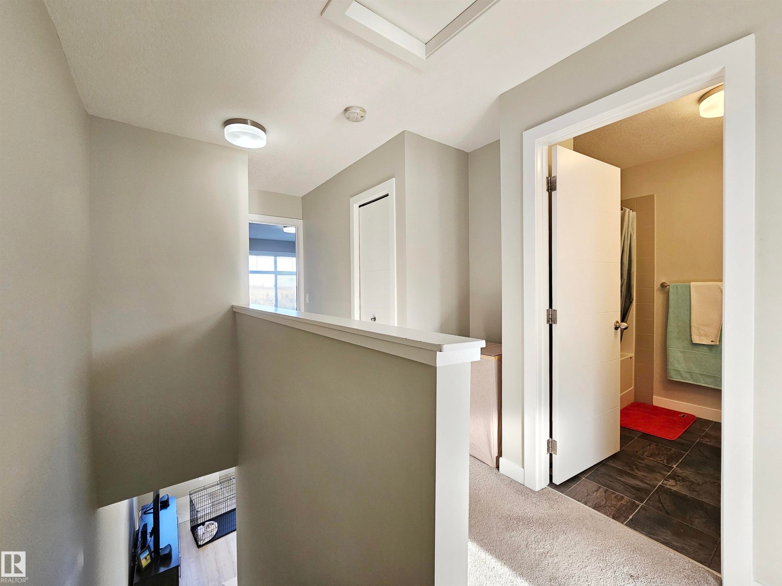 Hallway with dark carpet and an upstairs landing - 83 600 Bellerose Drive, St. Albert, AB - Indoor Photo Showing Other Room