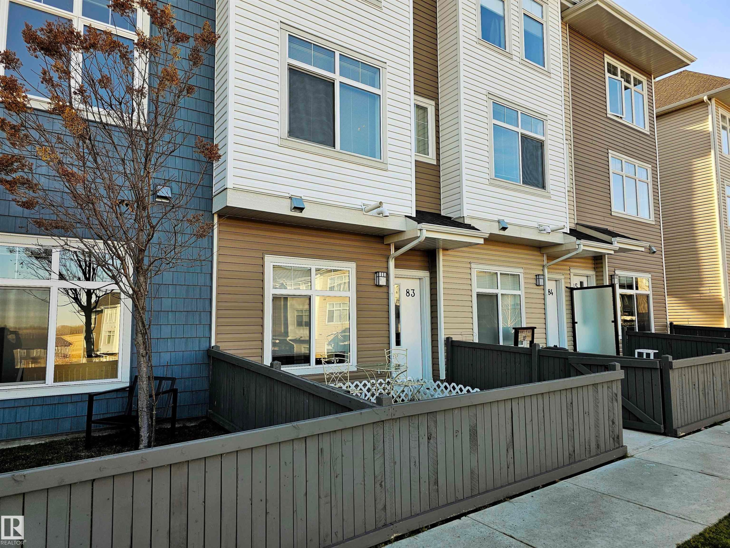 View of front of house with a residential view and a fenced front yard - 83 600 Bellerose Drive, St. Albert, AB - Outdoor
