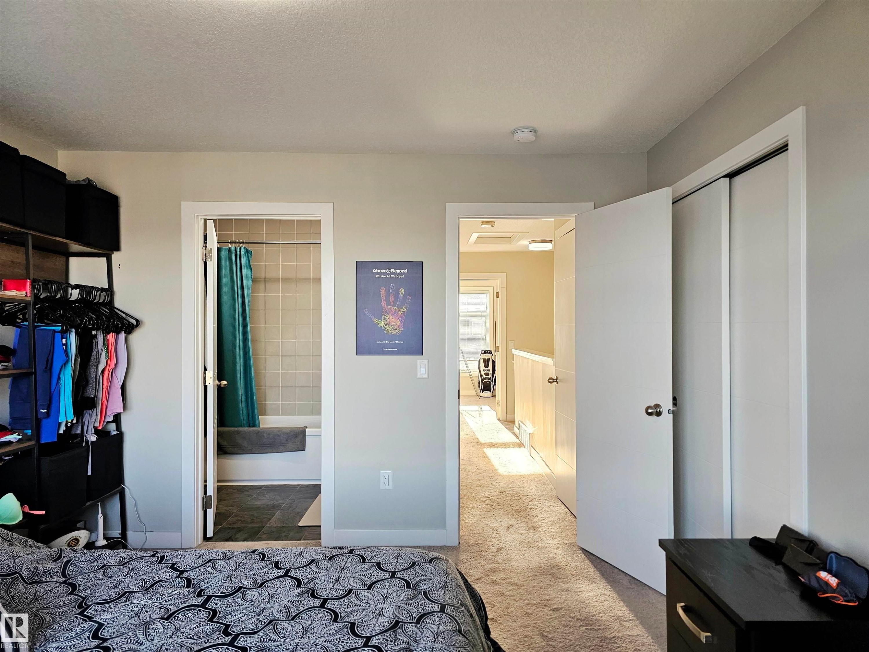 Bedroom featuring a closet, dark colored carpet, and connected bathroom - 83 600 Bellerose Drive, St. Albert, AB - Indoor Photo Showing Other Room