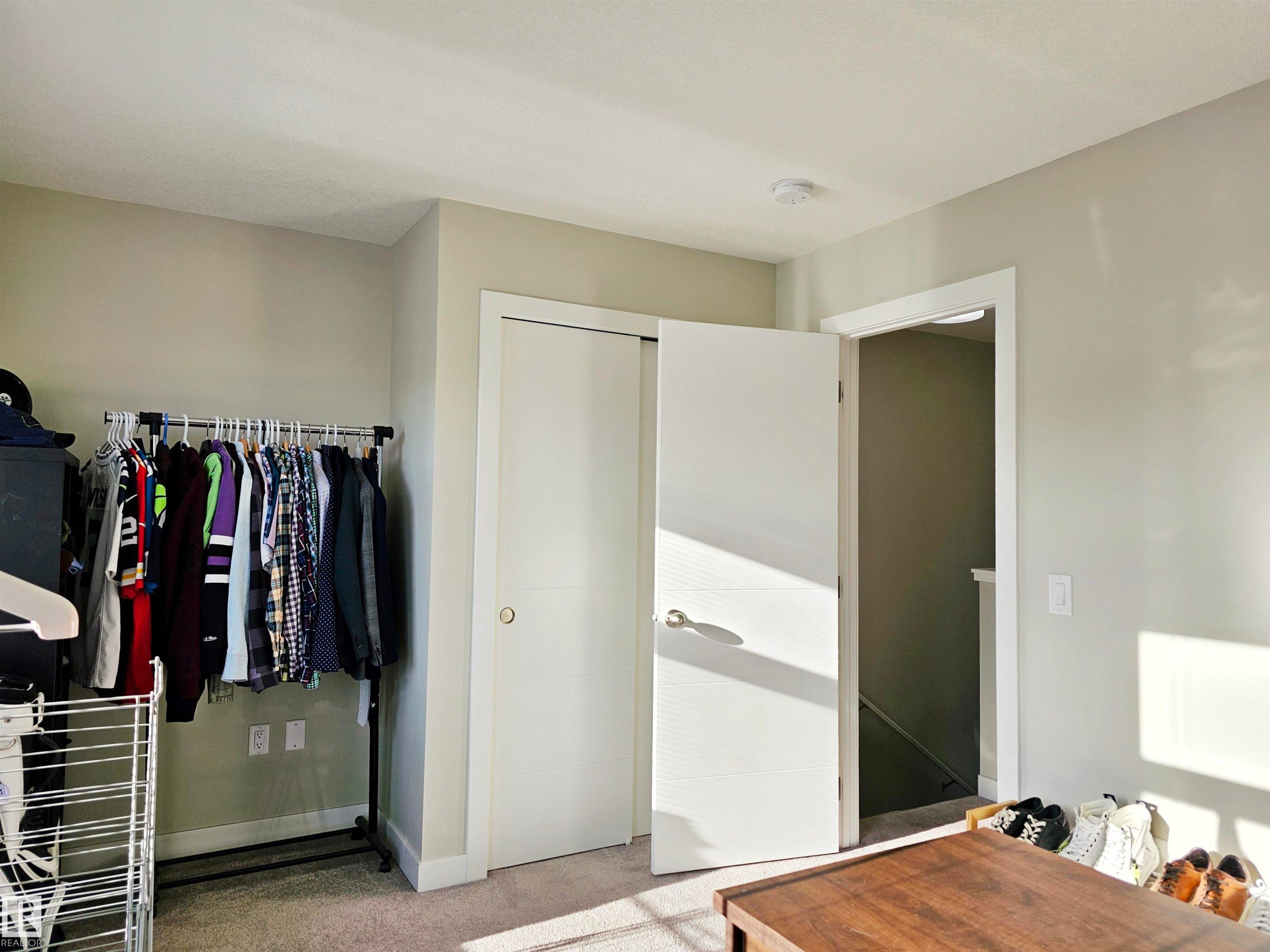 Bedroom with light carpet and a closet - 83 600 Bellerose Drive, St. Albert, AB - Indoor