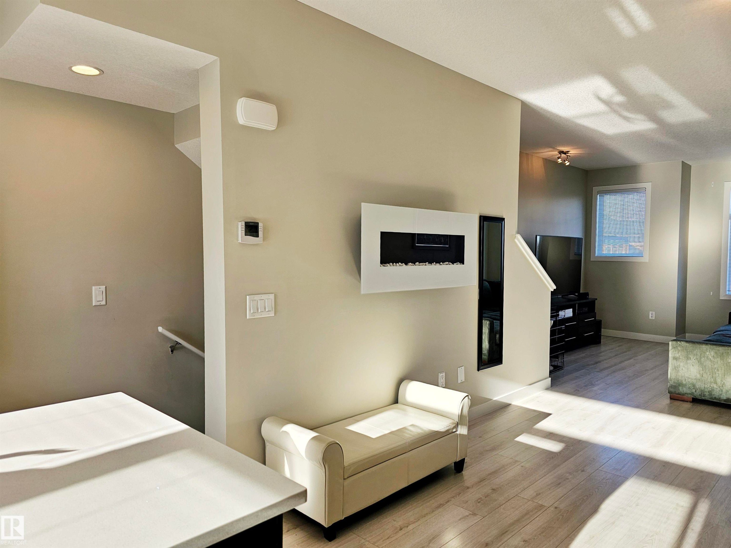 Living area featuring wood finished floors and baseboards - 83 600 Bellerose Drive, St. Albert, AB - Indoor Photo Showing Bedroom