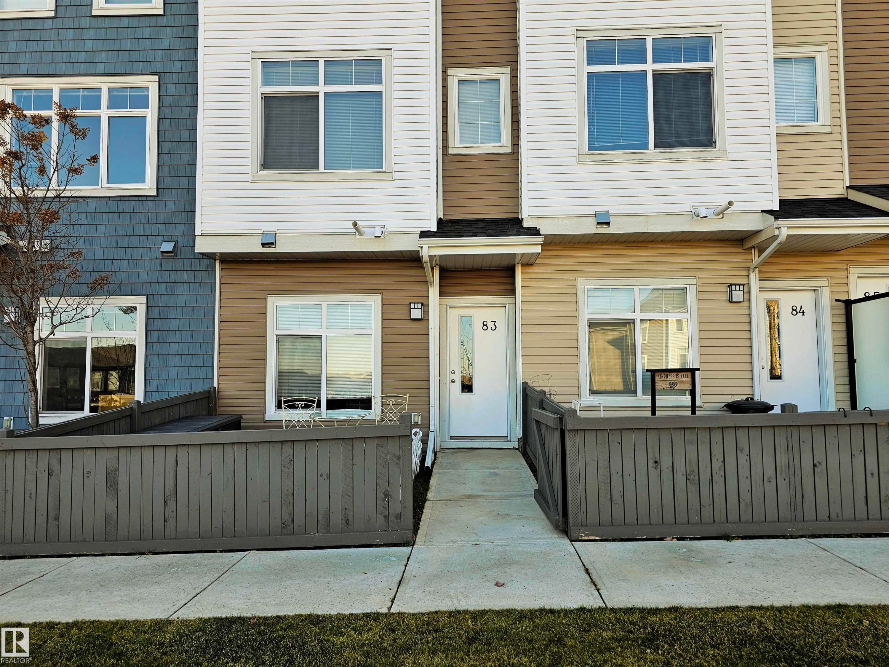 View of front of property featuring a fenced front yard - 83 600 Bellerose Drive, St. Albert, AB - Outdoor With Exterior