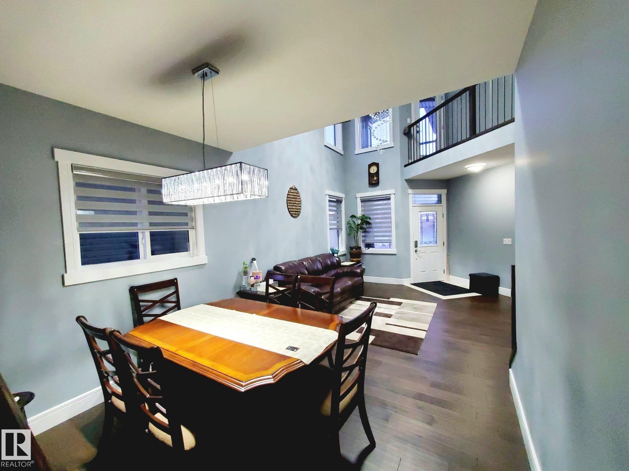 Dining area with dark wood-type flooring and a high ceiling - 1357 Watt Drive, Edmonton, AB - Indoor