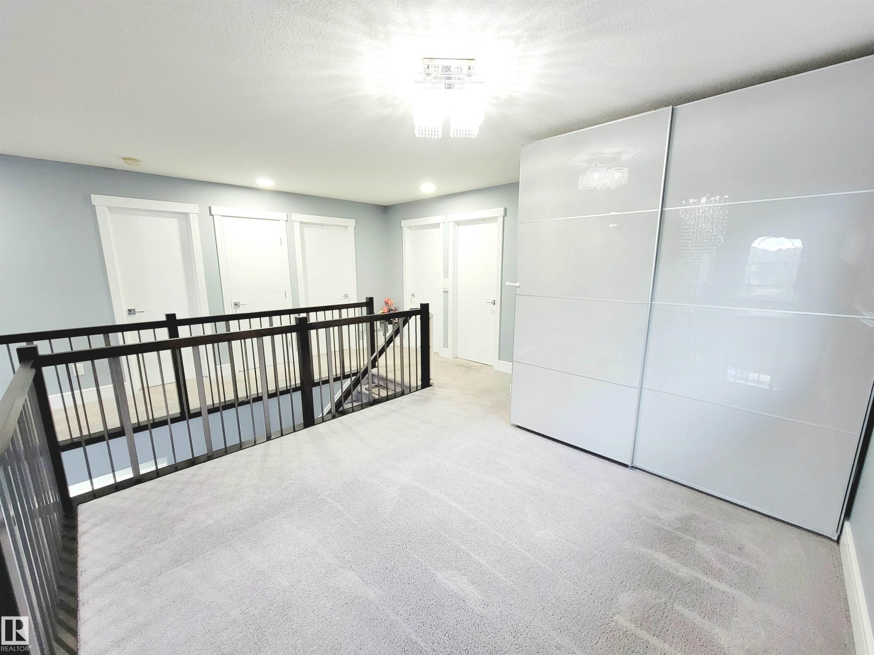 Hallway featuring light carpet, an upstairs landing, and recessed lighting - 1357 Watt Drive, Edmonton, AB - Indoor Photo Showing Other Room