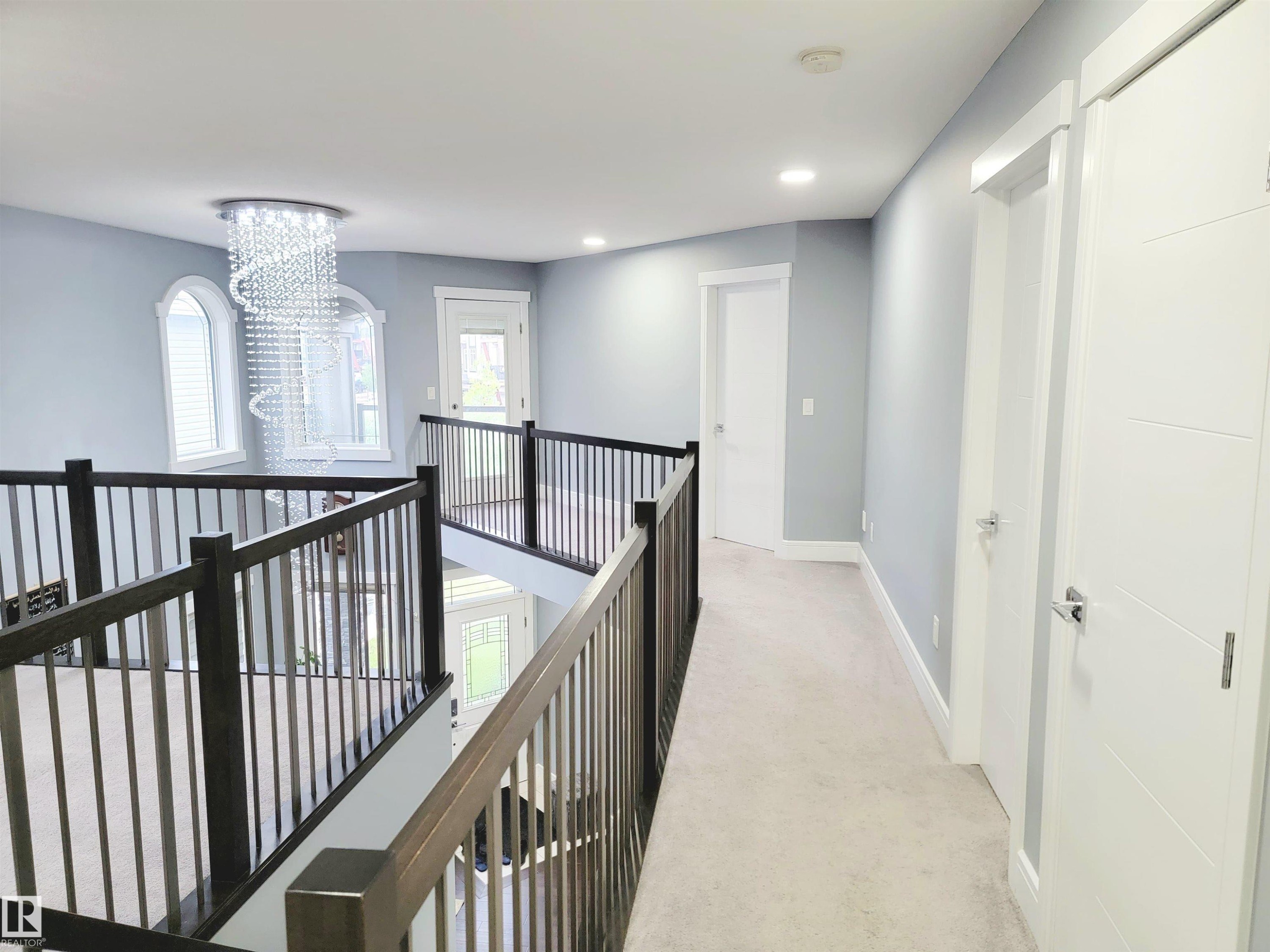 Hall featuring a chandelier, light carpet, recessed lighting, and an upstairs landing - 1357 Watt Drive, Edmonton, AB - Indoor Photo Showing Other Room
