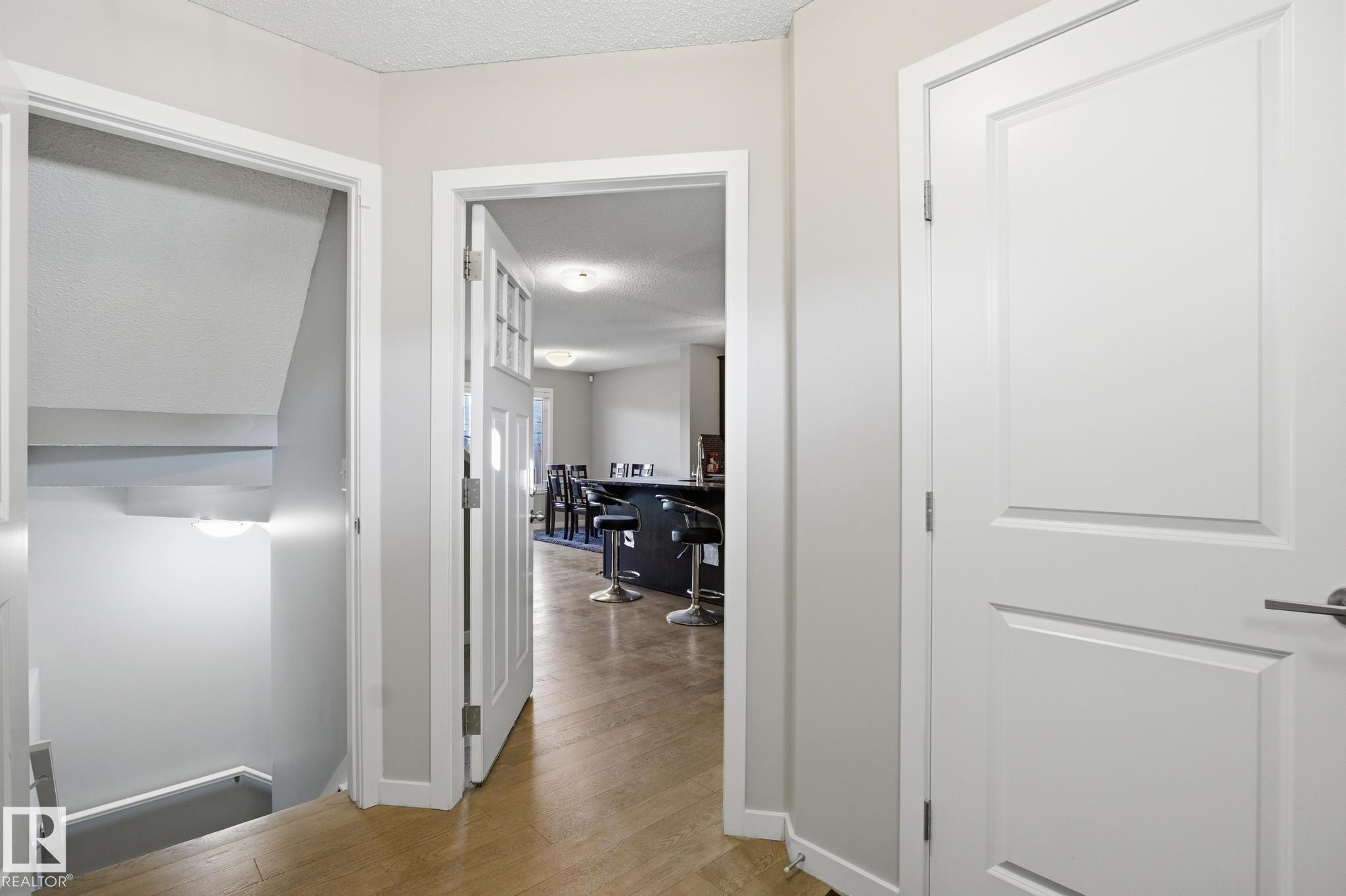 Hallway with a textured ceiling and light wood-type flooring - 893 Ebbers Crescent Nw, Edmonton, AB - Indoor Photo Showing Other Room