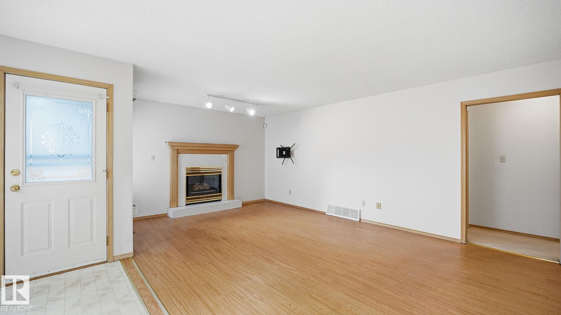 Edmonton, AB - Indoor Photo Showing Living Room With Fireplace