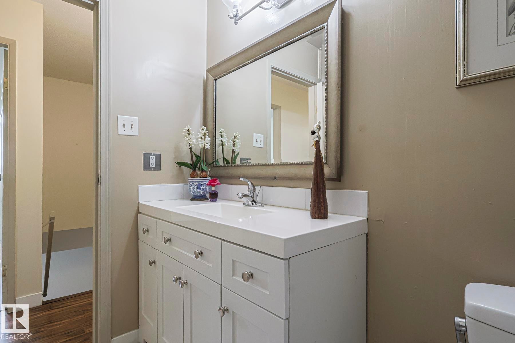 Half bathroom with vanity and dark wood-style floors - 51 Belmead Gardens, Edmonton, AB - Indoor Photo Showing Bathroom