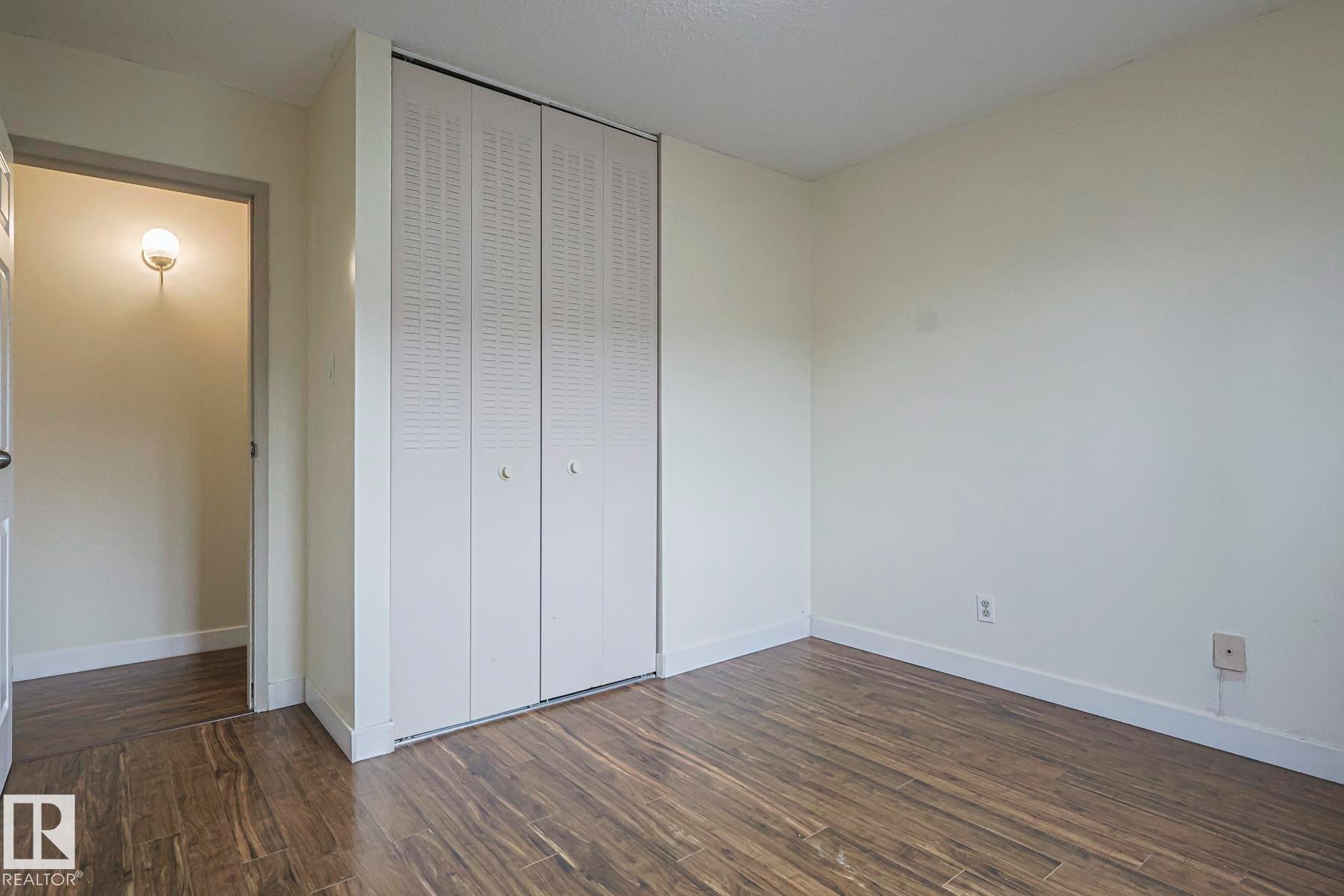 Unfurnished bedroom featuring dark wood finished floors and a closet - 51 Belmead Gardens, Edmonton, AB - Indoor Photo Showing Other Room
