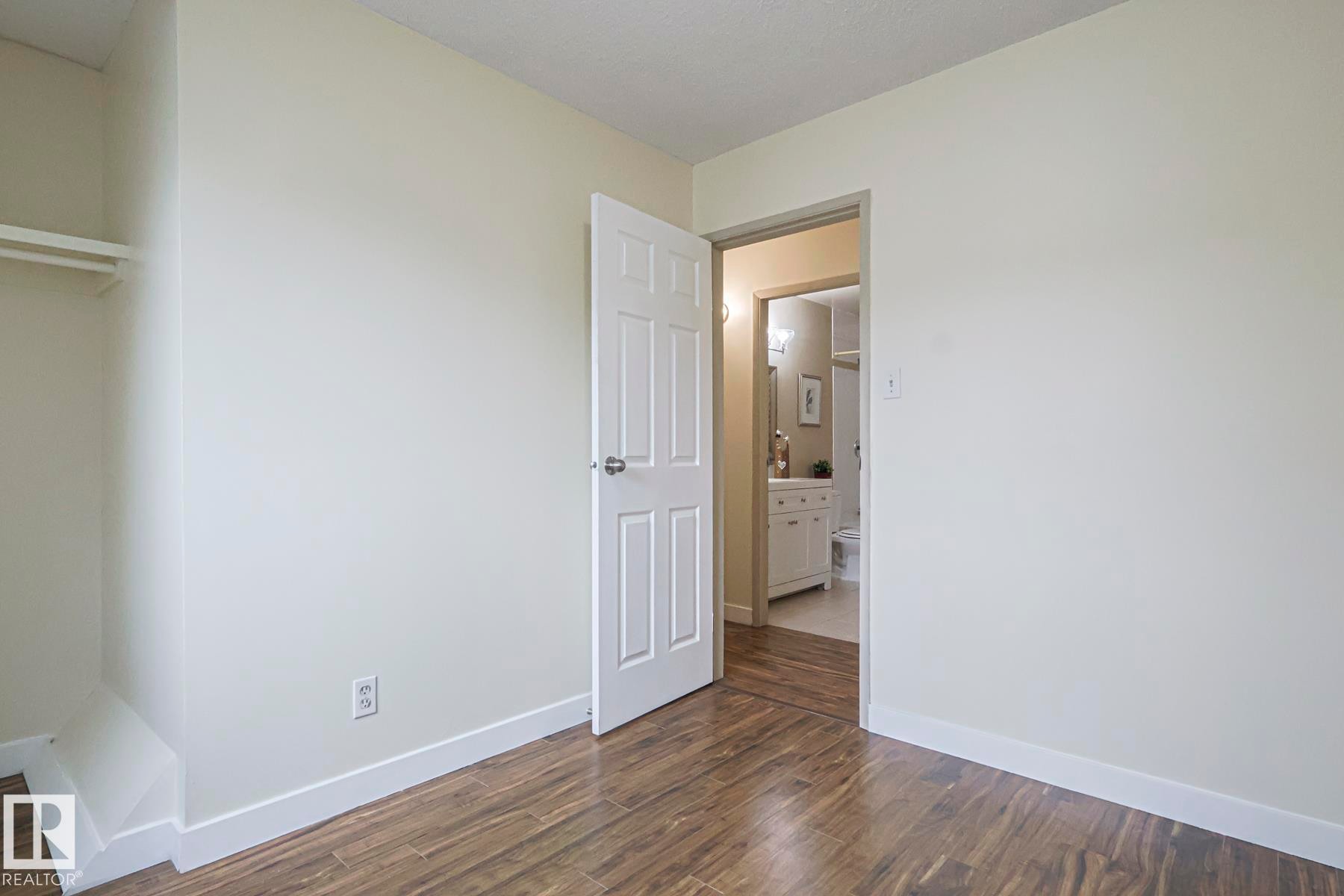 Unfurnished bedroom featuring baseboards and dark wood finished floors - 51 Belmead Gardens, Edmonton, AB - Indoor Photo Showing Other Room