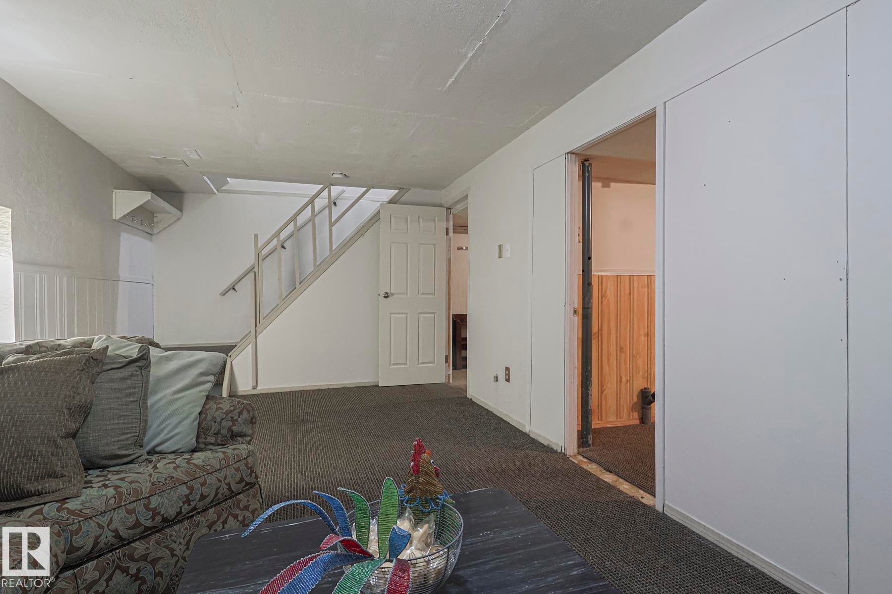 Unfurnished living room with stairway and carpet - 51 Belmead Gardens, Edmonton, AB - Indoor Photo Showing Other Room