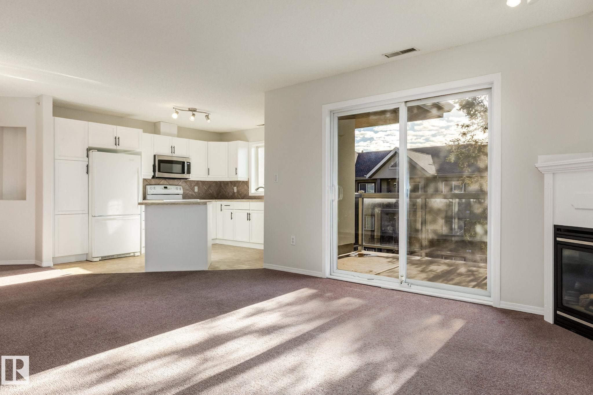 443 279 Suder Greens Drive, Edmonton, AB - Indoor Photo Showing Kitchen With Fireplace