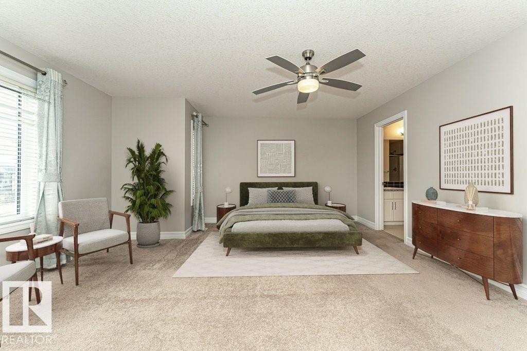 Carpeted bedroom featuring a textured ceiling, ceiling fan, and connected bathroom - 3198 Winspear Crescent Sw, Edmonton, AB - Indoor Photo Showing Bedroom