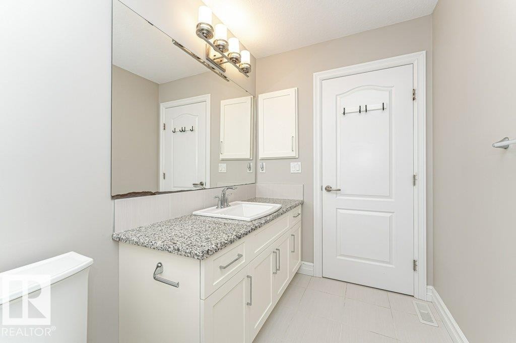 Bathroom featuring vanity and light tile patterned floors - 3198 Winspear Crescent Sw, Edmonton, AB - Indoor Photo Showing Bathroom