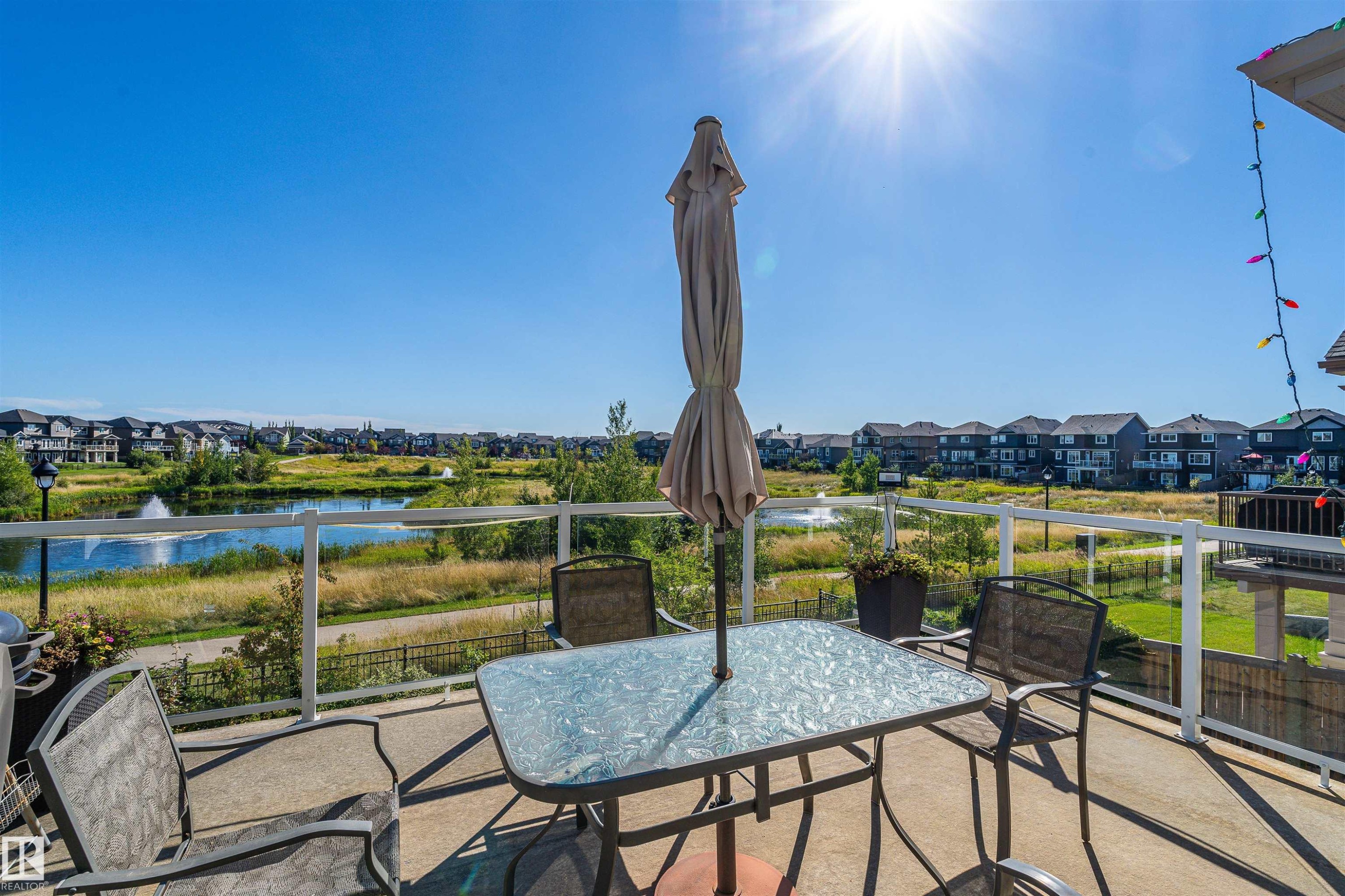 View of patio / terrace featuring outdoor dining space, a residential view, and a water view - 3198 Winspear Crescent Sw, Edmonton, AB - Outdoor With View