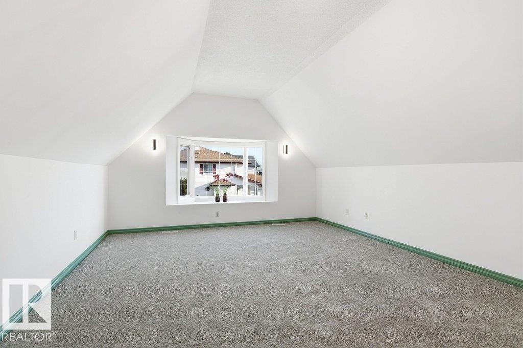 Additional living space with vaulted ceiling and carpet floors - 1112 118A Street Nw, Edmonton, AB - Indoor Photo Showing Other Room