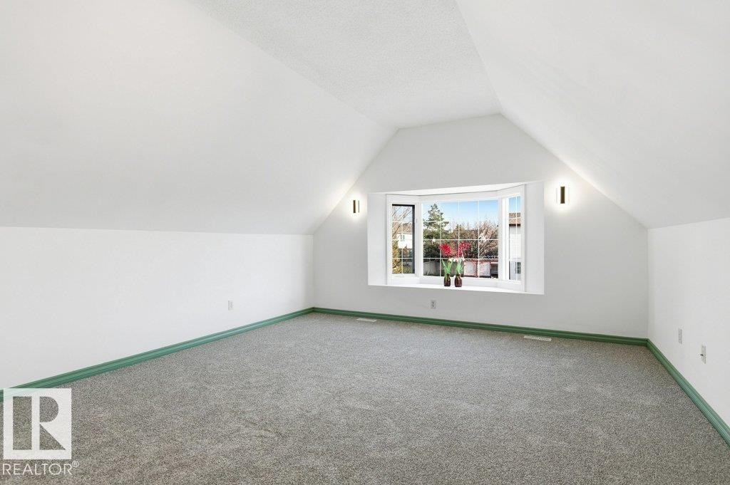 Additional living space featuring vaulted ceiling and carpet flooring - 1112 118A Street Nw, Edmonton, AB - Indoor Photo Showing Other Room