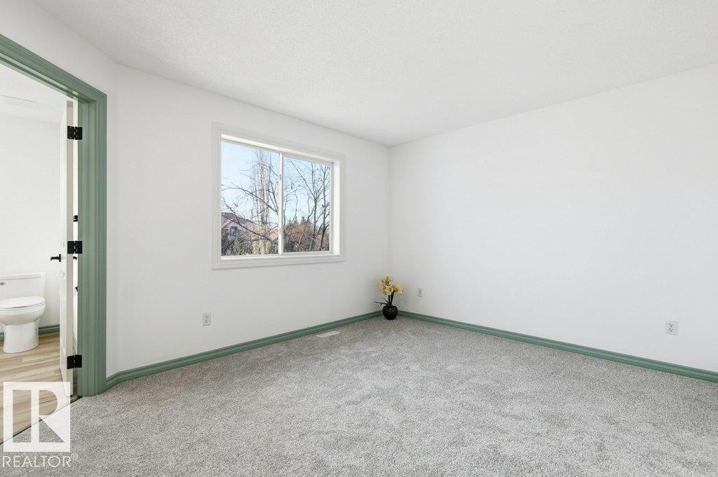 Carpeted spare room featuring baseboards - 1112 118A Street Nw, Edmonton, AB - Indoor Photo Showing Other Room