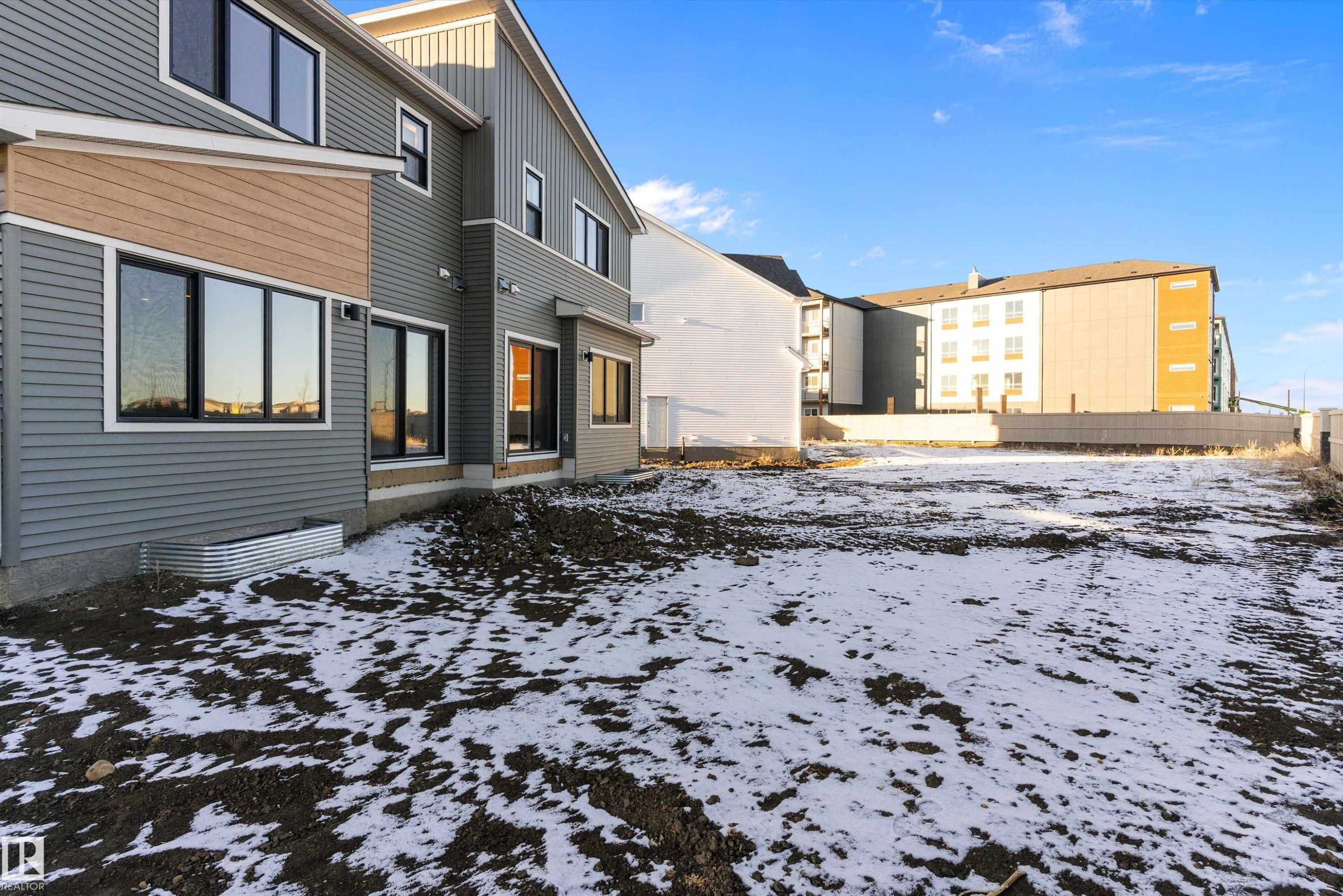 Snow covered back of property featuring board and batten siding - 823 Rowan Close, Edmonton, AB - Outdoor