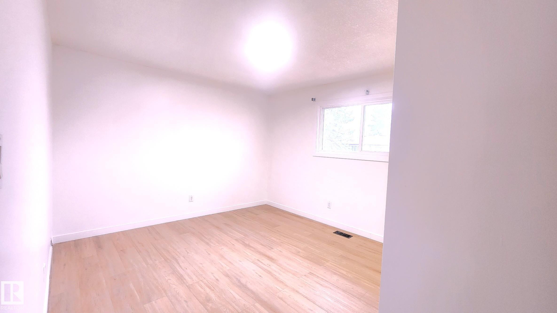 Unfurnished room with light wood-type flooring and baseboards - 11516 133A Avenue, Edmonton, AB - Indoor Photo Showing Other Room