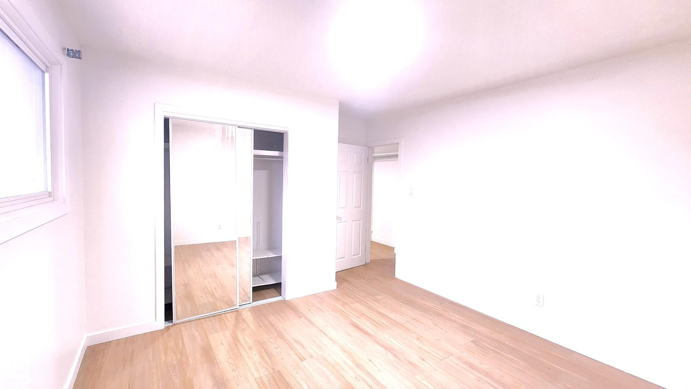 Unfurnished bedroom with wood finished floors and a closet - 11516 133A Avenue, Edmonton, AB - Indoor Photo Showing Other Room