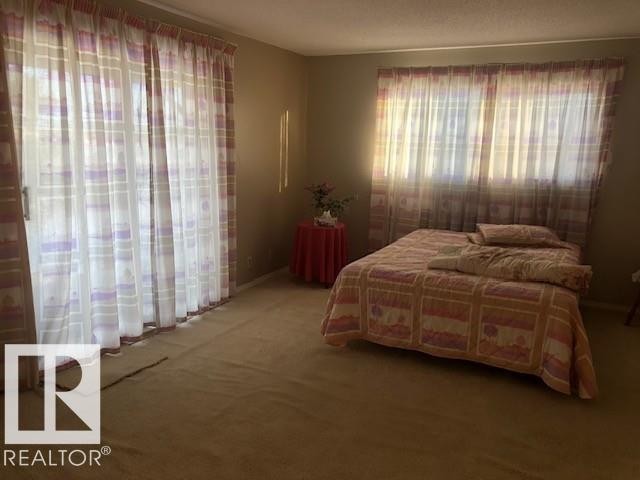 Bedroom featuring carpet - 4213 42 Avenue, Innisfail, AB - Indoor Photo Showing Bedroom