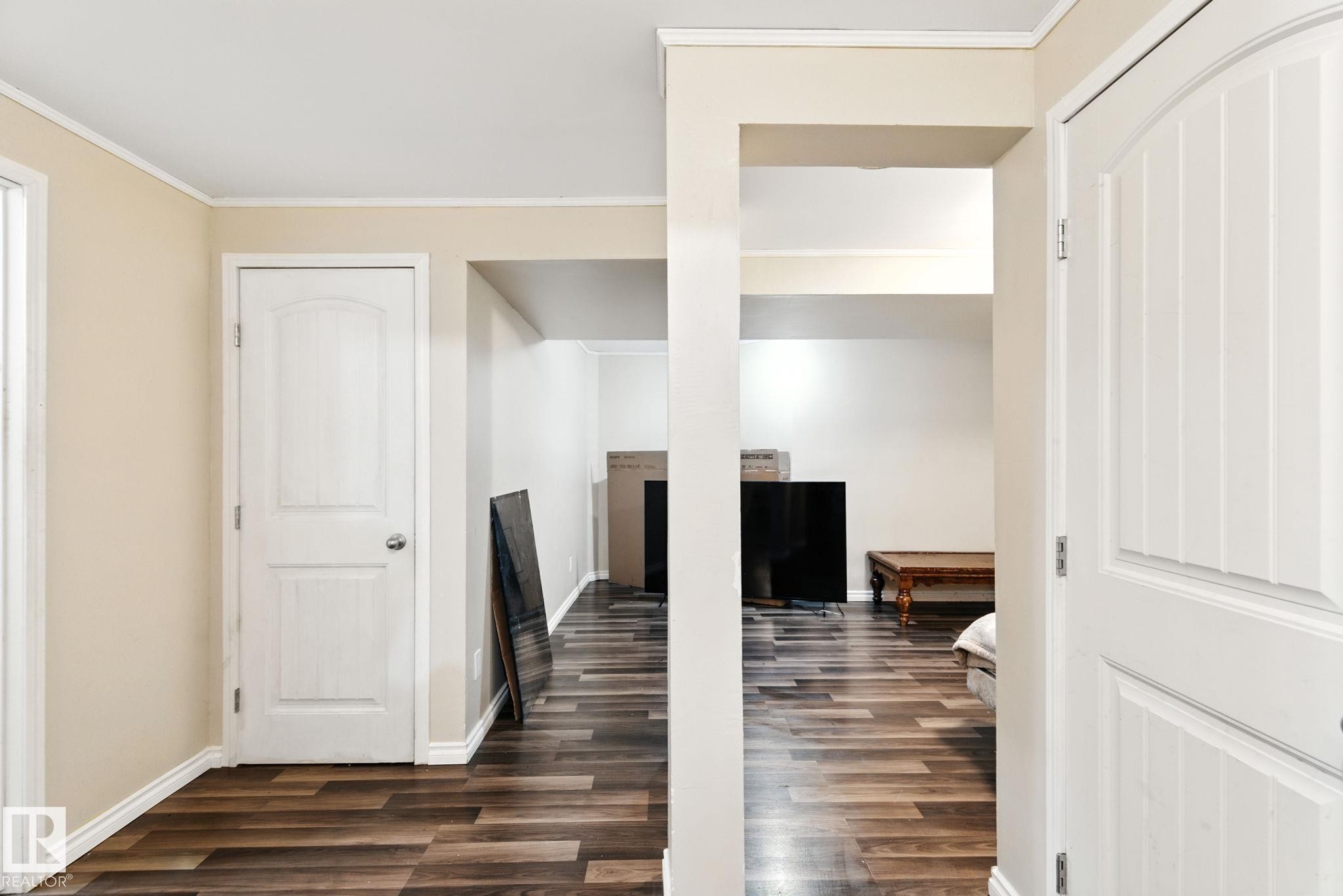 Corridor with dark wood-style flooring and crown molding - 7836 7 Avenue, Edmonton, AB - Indoor Photo Showing Other Room