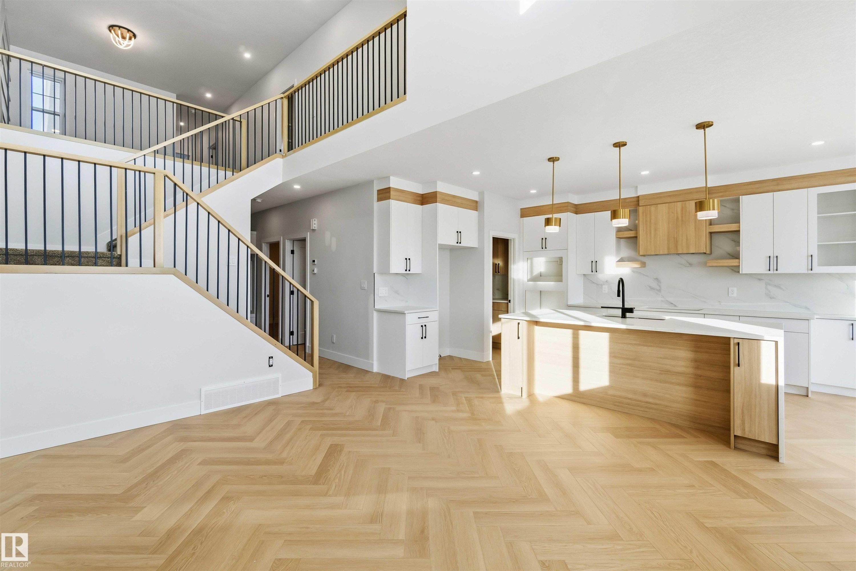 Dual tone kitchen featuring two tone cabinetry, parquet flooring, modern cabinets, backsplash, and pendant lighting - 94 Eldridge Pointe, St. Albert, AB - Indoor Photo Showing Kitchen