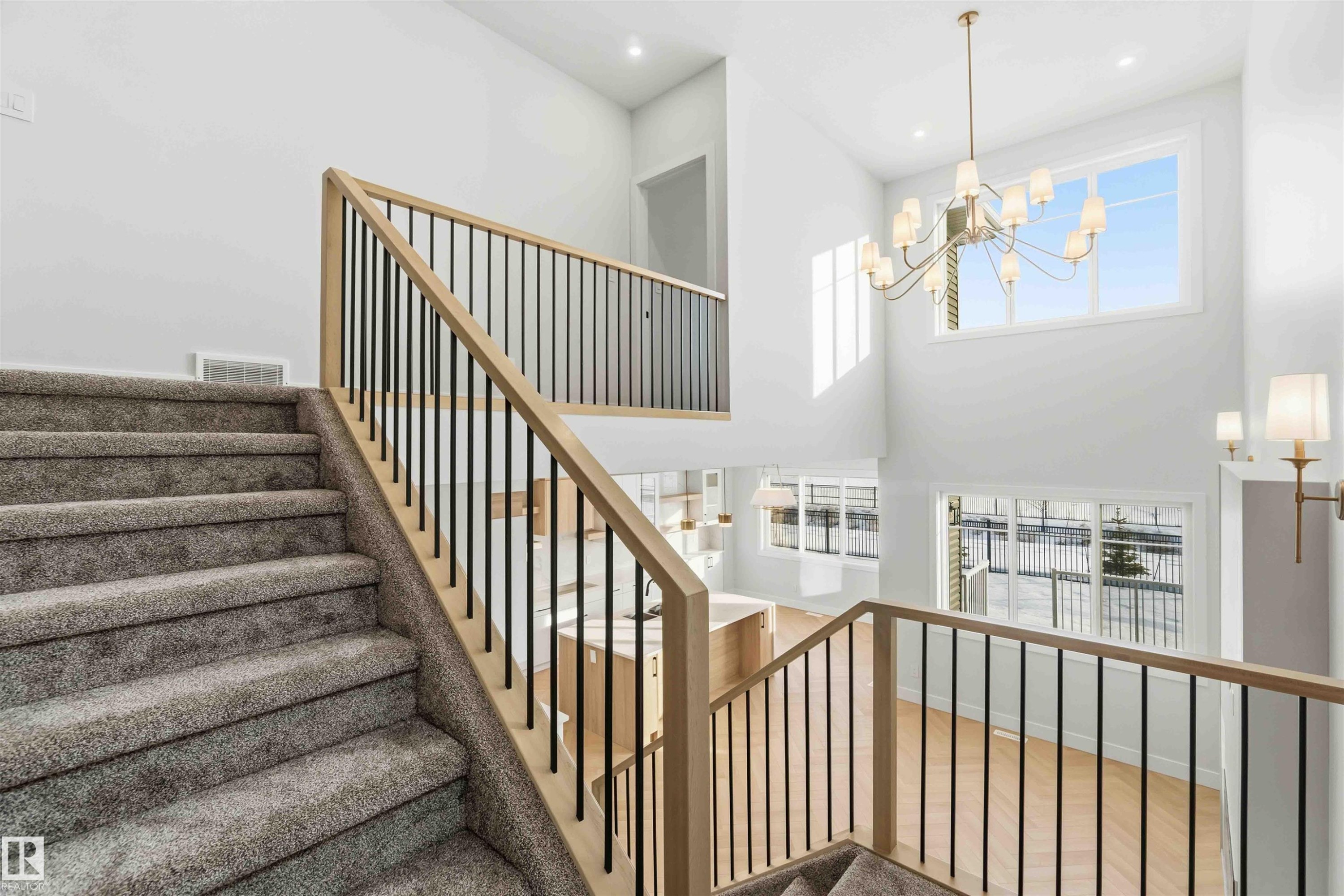 Stairs featuring suspended lighting and a high ceiling - 94 Eldridge Pointe, St. Albert, AB - Indoor Photo Showing Other Room
