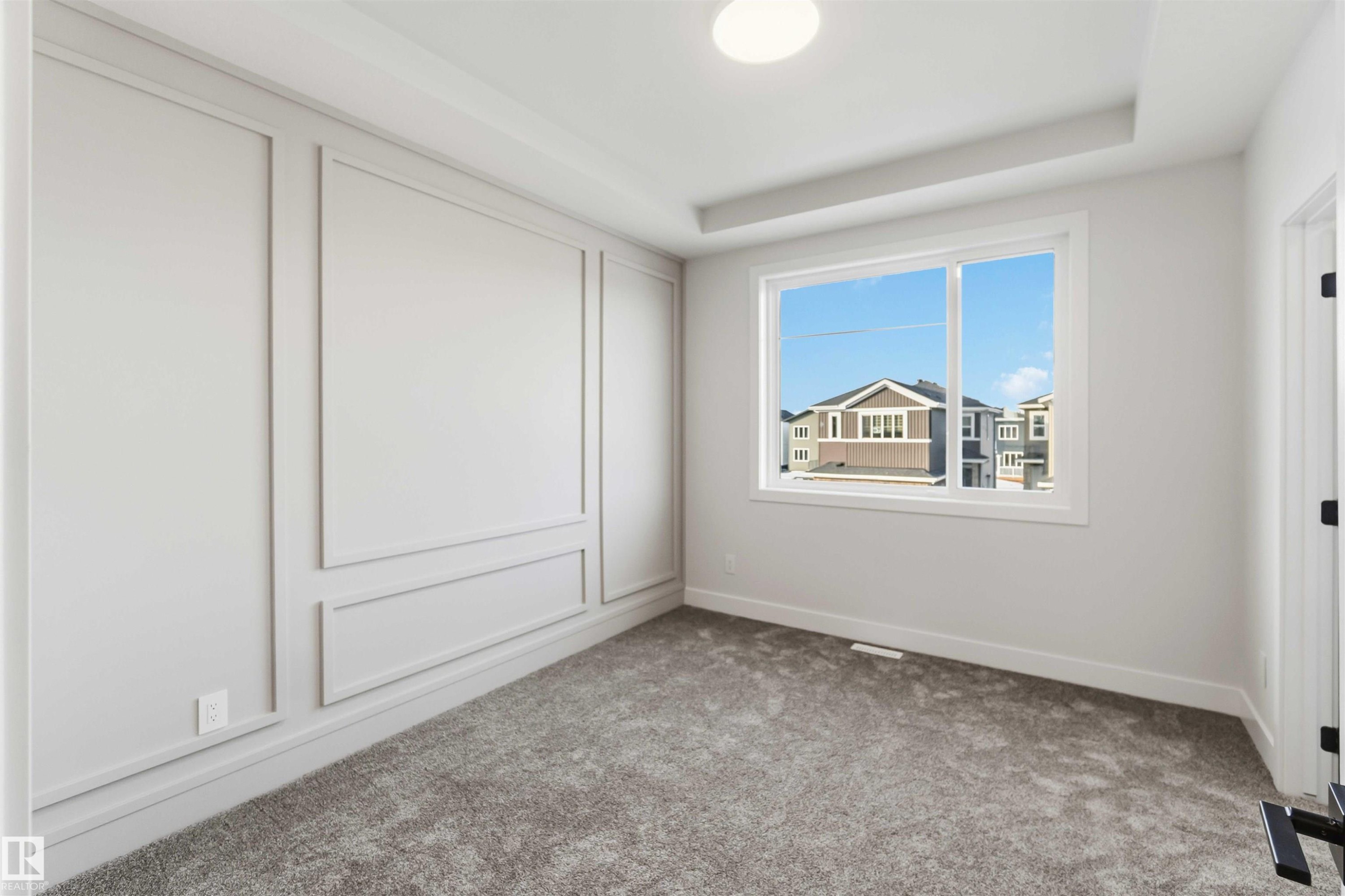Unfurnished bedroom with carpet and a tray ceiling - 94 Eldridge Pointe, St. Albert, AB - Indoor Photo Showing Other Room