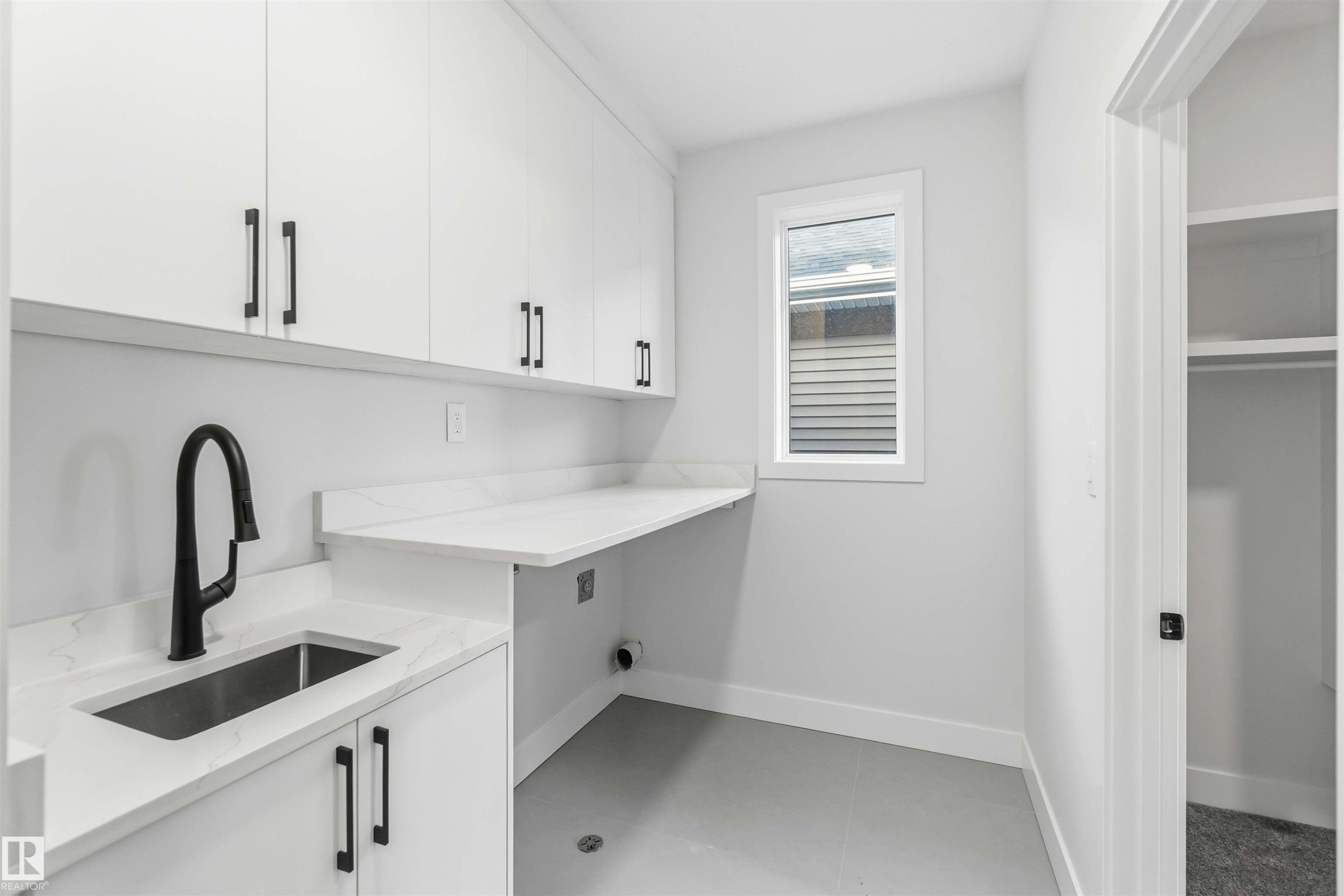 Laundry room featuring cabinet space and baseboards - 94 Eldridge Pointe, St. Albert, AB - Indoor Photo Showing Kitchen