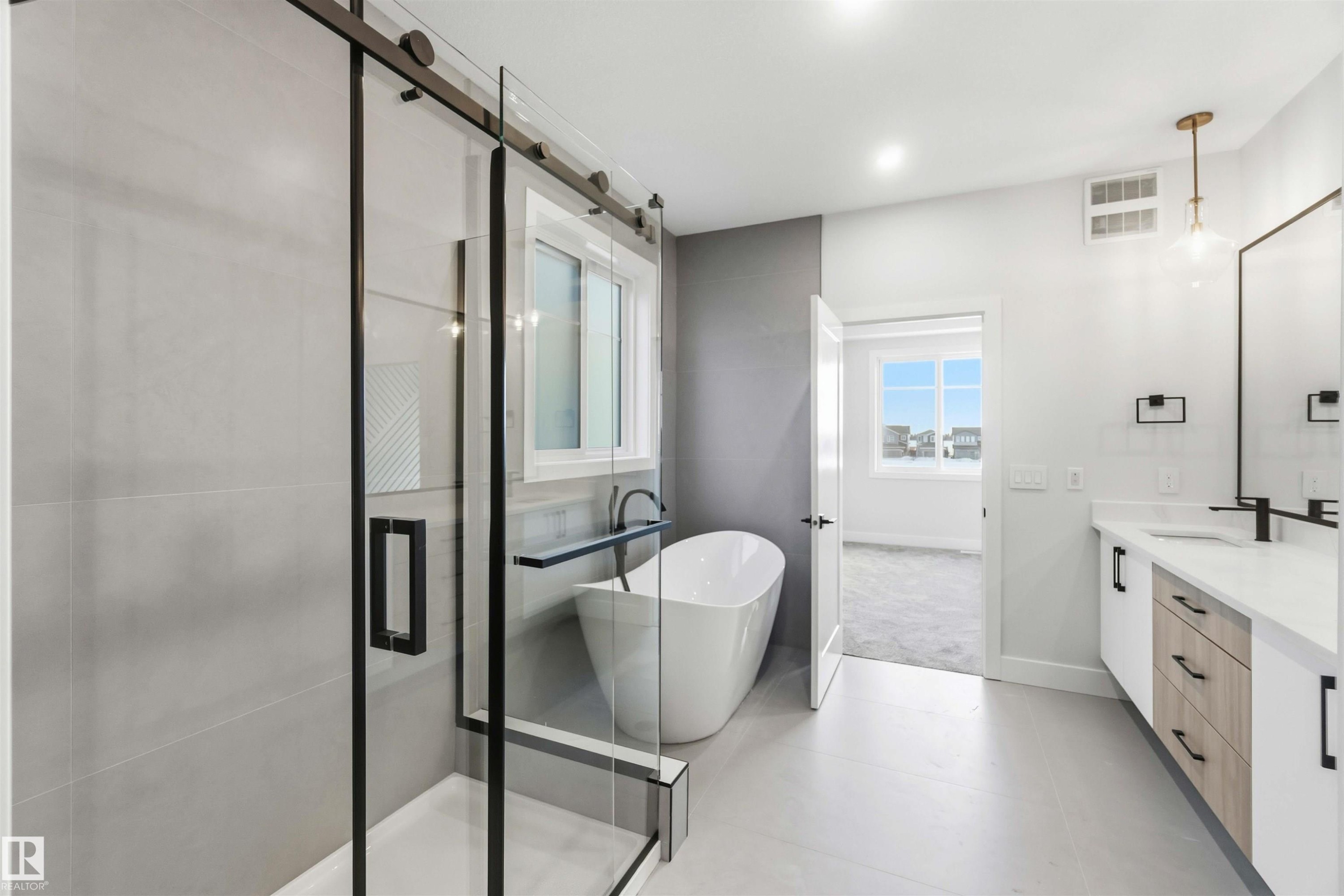 Full bathroom featuring vanity, a stall shower, a freestanding tub, and light tile patterned flooring - 94 Eldridge Pointe, St. Albert, AB - Indoor Photo Showing Bathroom