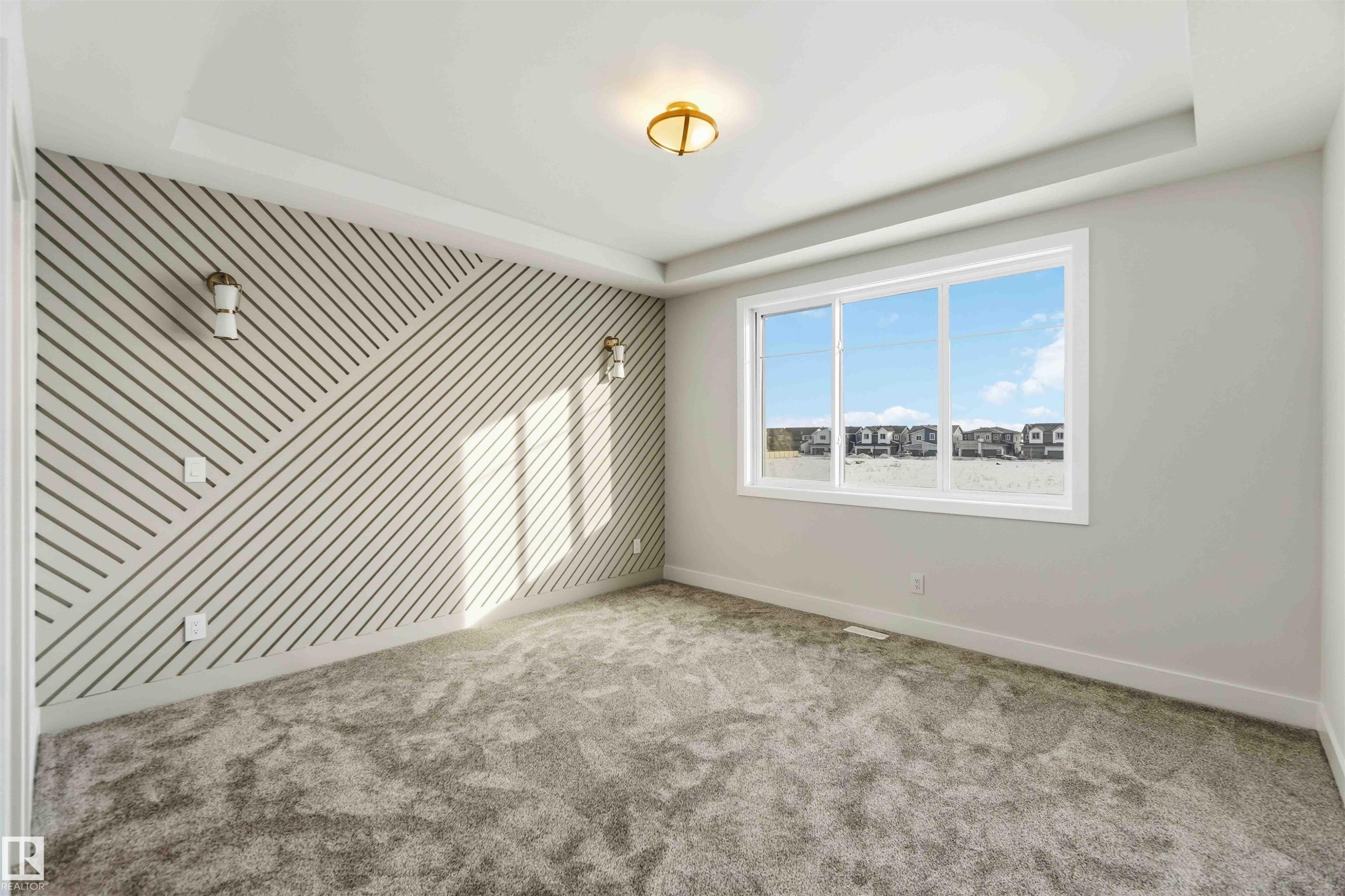 Carpeted empty room featuring baseboards and a tray ceiling - 94 Eldridge Pointe, St. Albert, AB - Indoor Photo Showing Other Room