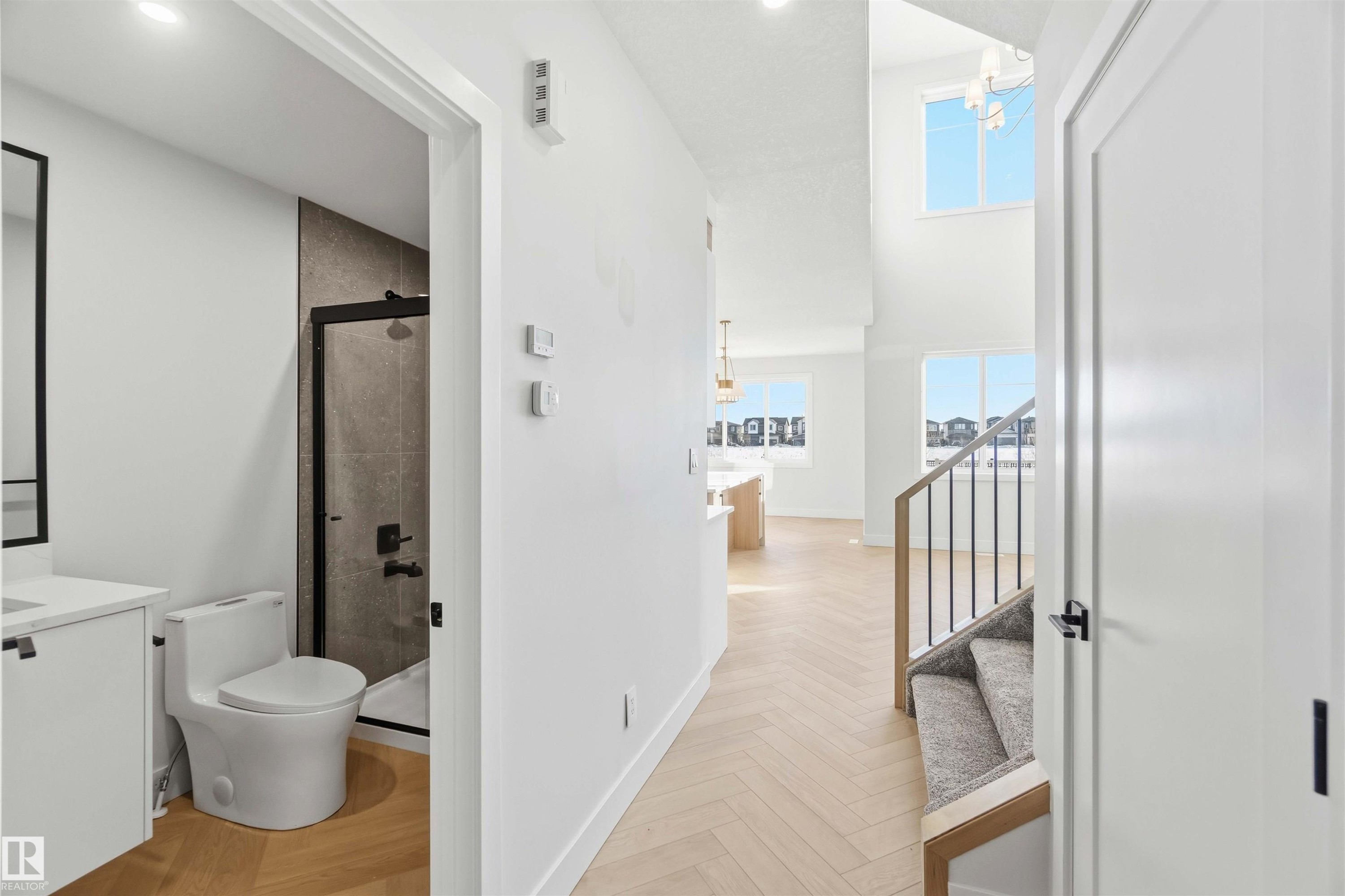 Full bathroom featuring a stall shower, vanity, parquet floors, and plenty of natural light - 94 Eldridge Pointe, St. Albert, AB - Indoor Photo Showing Bathroom