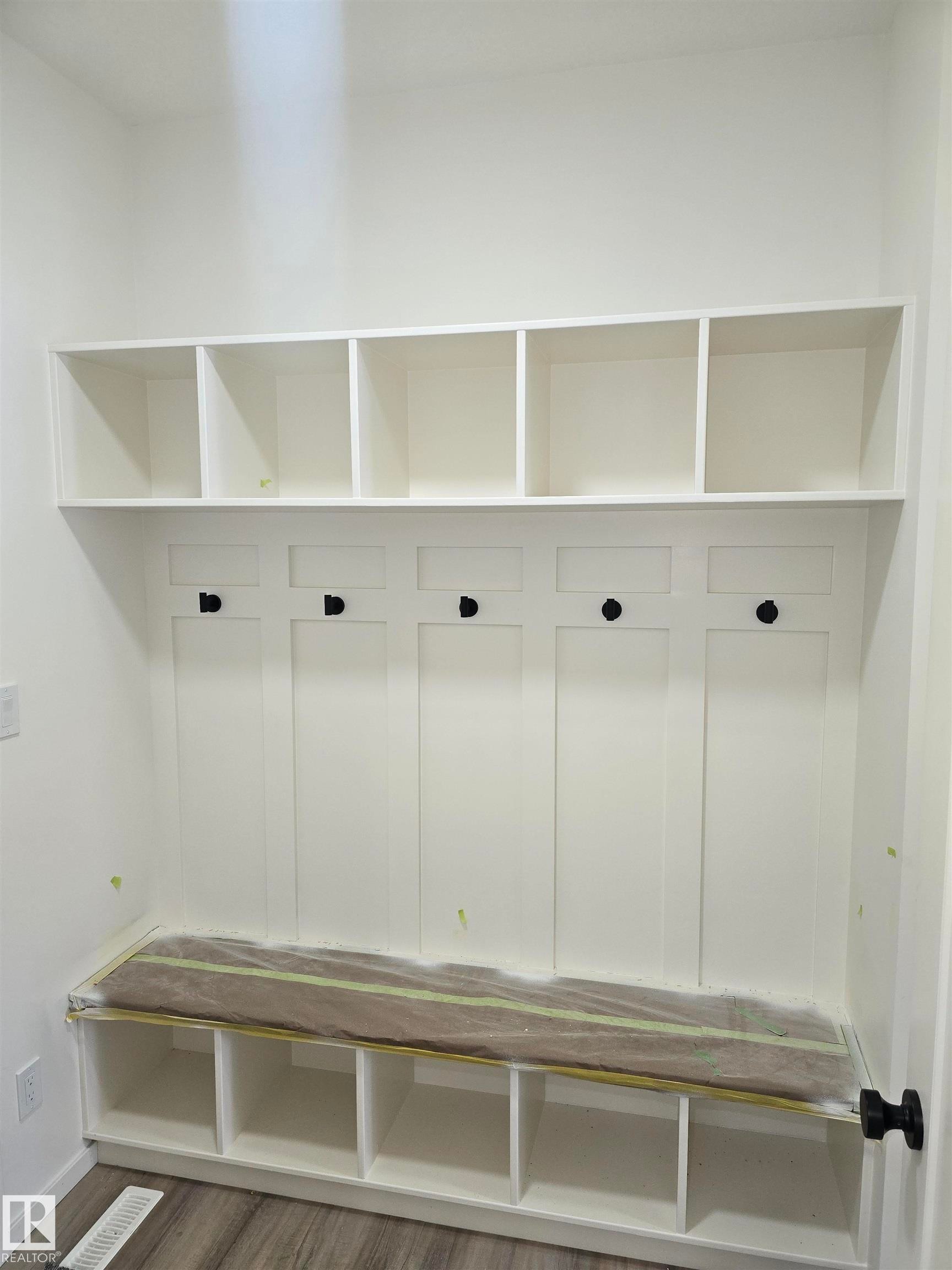 Mudroom featuring wood finished floors and baseboards - 7706 174A Avenue, Edmonton, AB - Indoor With Storage