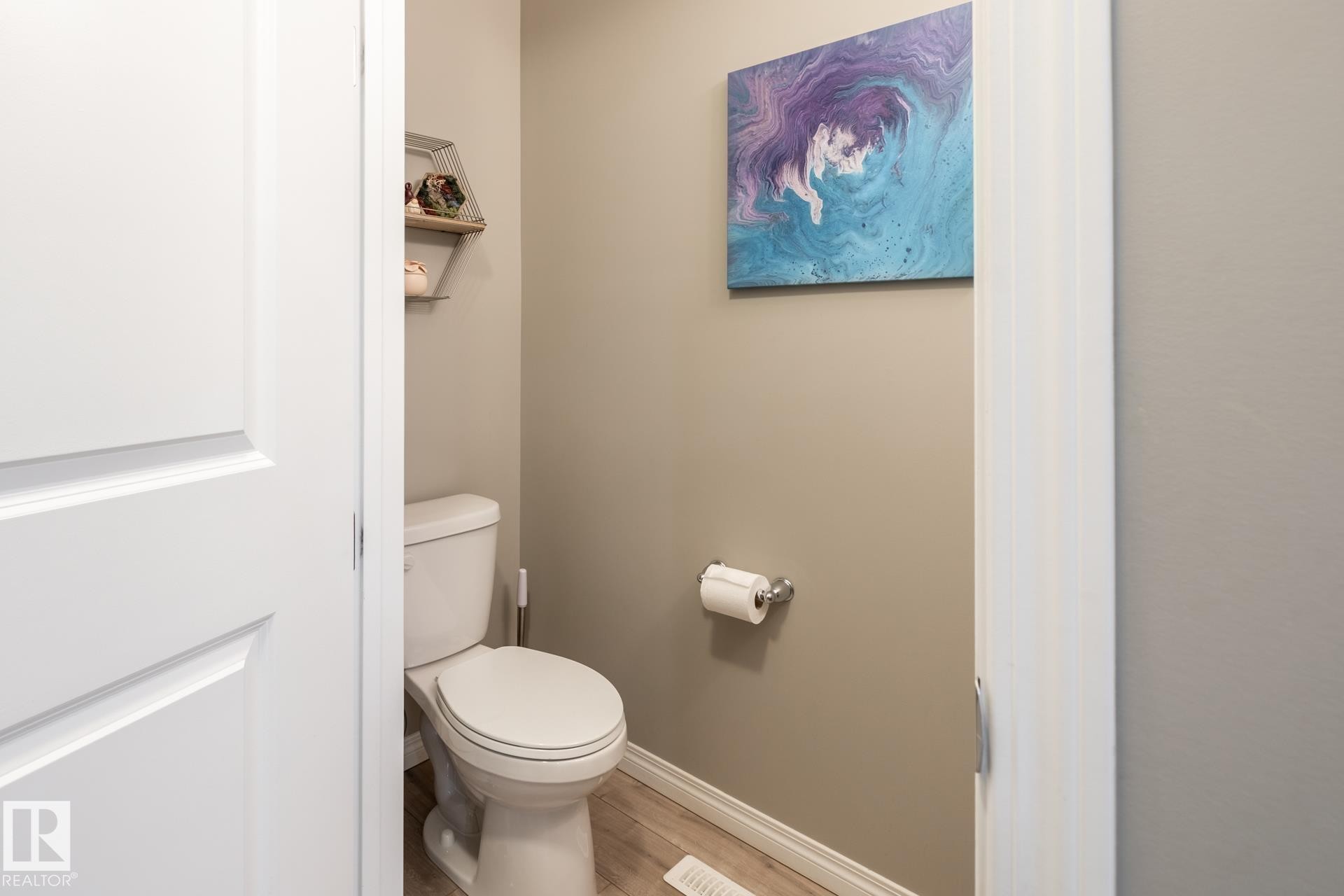 Bathroom featuring baseboards and wood finished floors - 5 2072 Wonnacott Way, Edmonton, AB - Indoor Photo Showing Bathroom