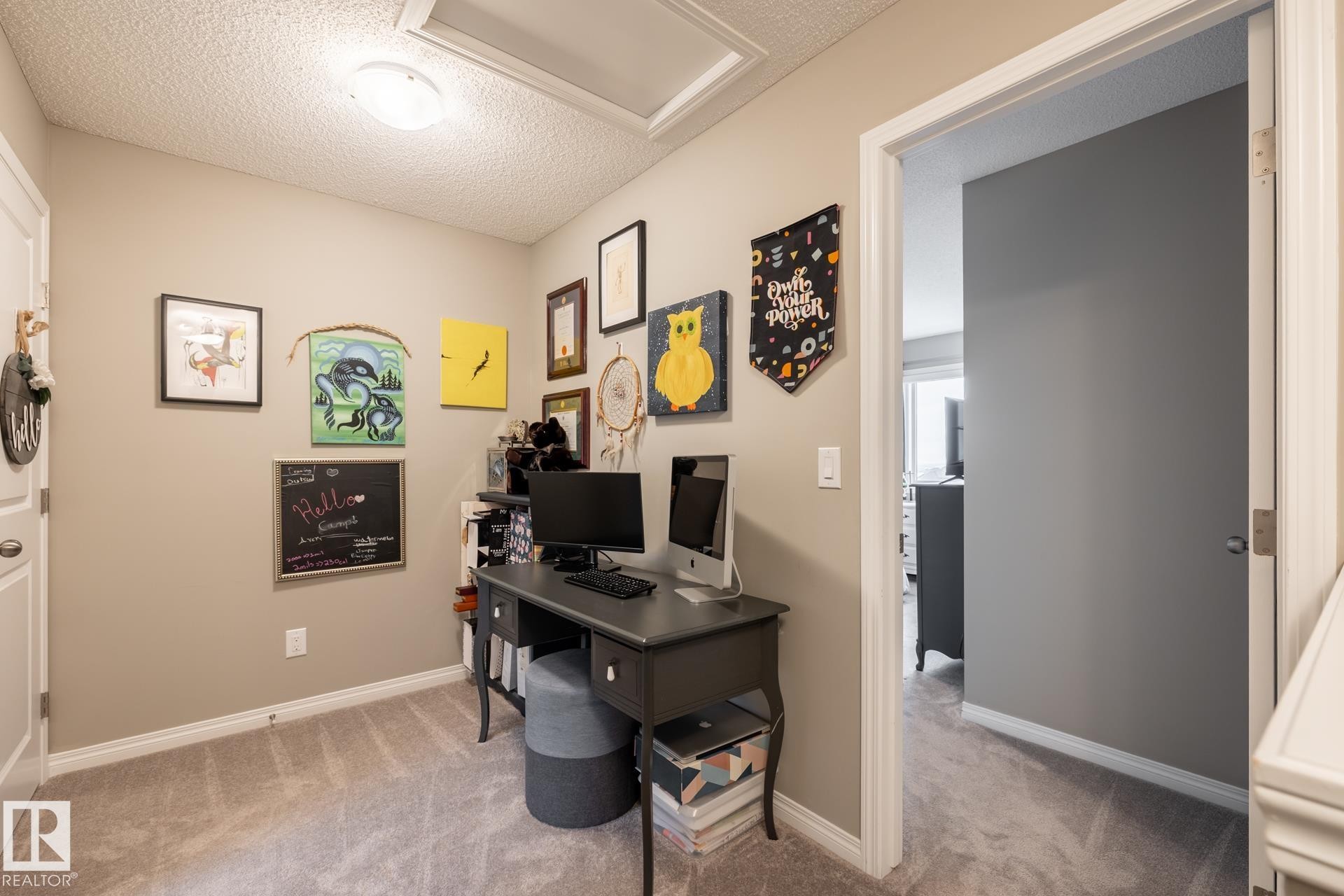 Office area with a textured ceiling and light carpet - 5 2072 Wonnacott Way, Edmonton, AB - Indoor