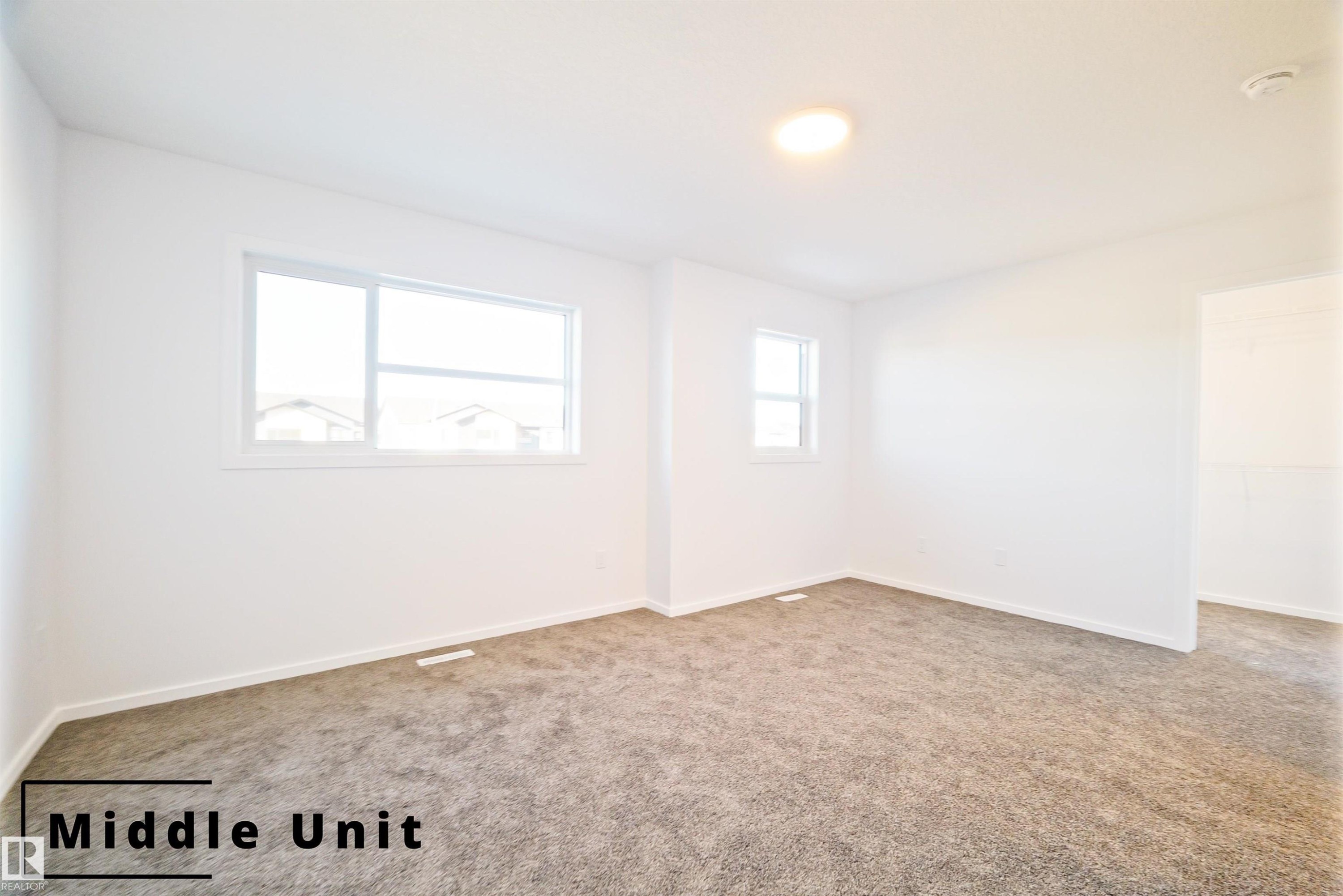 Empty room featuring baseboards and carpet flooring - 7585 174A Avenue, Edmonton, AB - Indoor Photo Showing Other Room