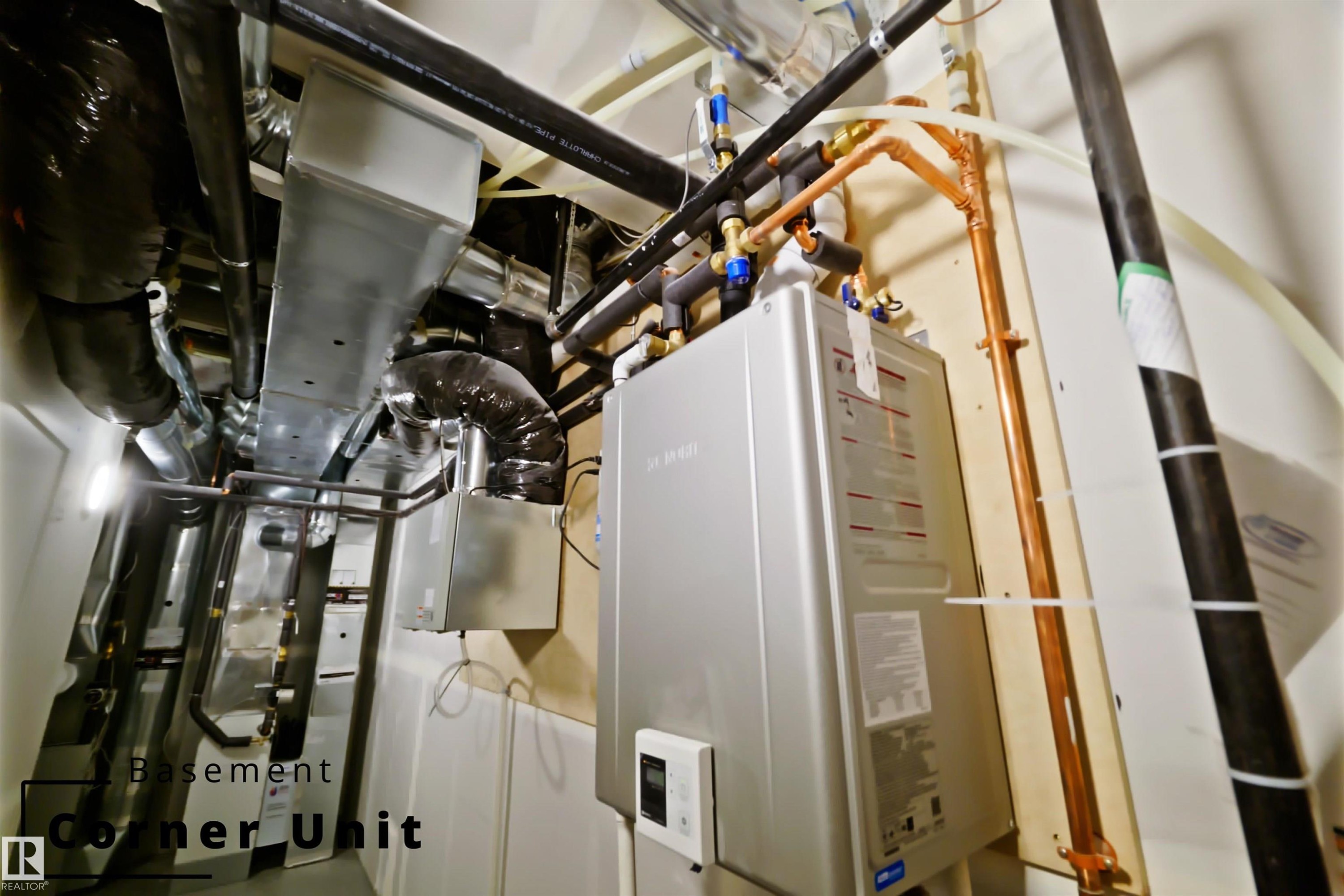 Utilities featuring tankless water heater - 7585 174A Avenue, Edmonton, AB - Indoor Photo Showing Basement